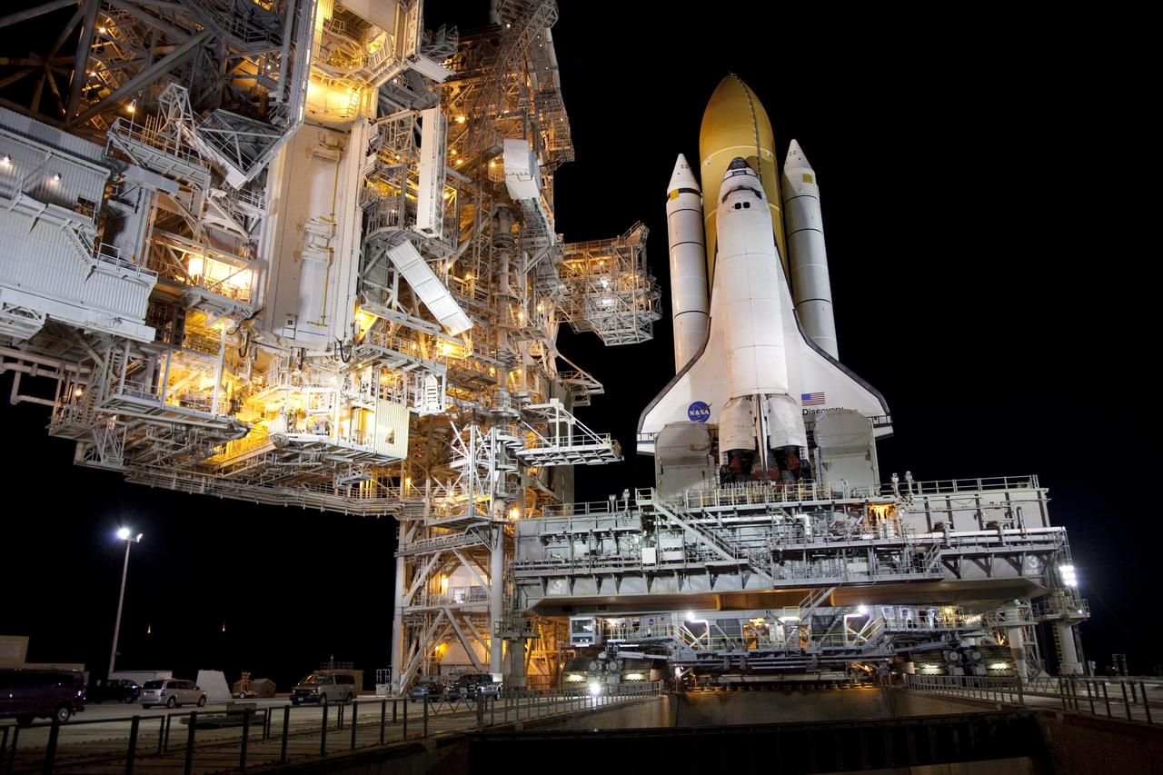 CAPE CANAVERAL, Fla. -- Space shuttle Discovery, secured to a crawler-transporter, slowly moves away from Launch Pad 39A at NASA's Kennedy Space Center in Florida. The 3.4-mile trek, called rollback, to the Vehicle Assembly Building began at 10:48 p.m. and took about eight hours. Next, Discovery's external fuel tank will be examined and foam reapplied where 89 sensors were installed on the tank's aluminum skin for an instrumented tanking test on Dec. 17. The sensors were used to measure changes in the tank as super-cold propellants were pumped in and drained out. Data and analysis from the test will be used to determine what caused the tops of two, 21-foot-long support beams, called stringers, on the outside of the intertank to crack during fueling on Nov. 5.      Discovery's next launch opportunity to the International Space Station on the STS-133 mission is no earlier than Feb. 3, 2011. For more information on STS-133, visit www.nasa.gov/mission_pages/shuttle/shuttlemissions/sts133/. Photo credit: NASA/Frank Michaux