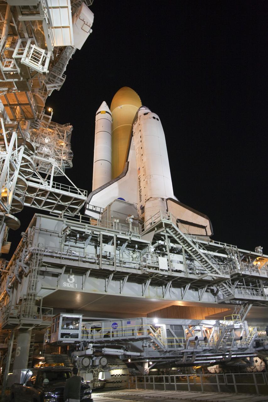 CAPE CANAVERAL, Fla. -- Space shuttle Discovery, secured to a crawler-transporter, begins its 3.4-mile trek, known as rollback, from Launch Pad 39A to the Vehicle Assembly Building at NASA's Kennedy Space Center in Florida. Rollback began at 10:48 p.m. and took about eight hours. Next, Discovery's external fuel tank will be examined and foam reapplied where 89 sensors were installed on the tank's aluminum skin for an instrumented tanking test on Dec. 17. The sensors were used to measure changes in the tank as super-cold propellants were pumped in and drained out. Data and analysis from the test will be used to determine what caused the tops of two, 21-foot-long support beams, called stringers, on the outside of the intertank to crack during fueling on Nov. 5.    Discovery's next launch opportunity to the International Space Station on the STS-133 mission is no earlier than Feb. 3, 2011. For more information on STS-133, visit www.nasa.gov/mission_pages/shuttle/shuttlemissions/sts133/. Photo credit: NASA/Frank Michaux
