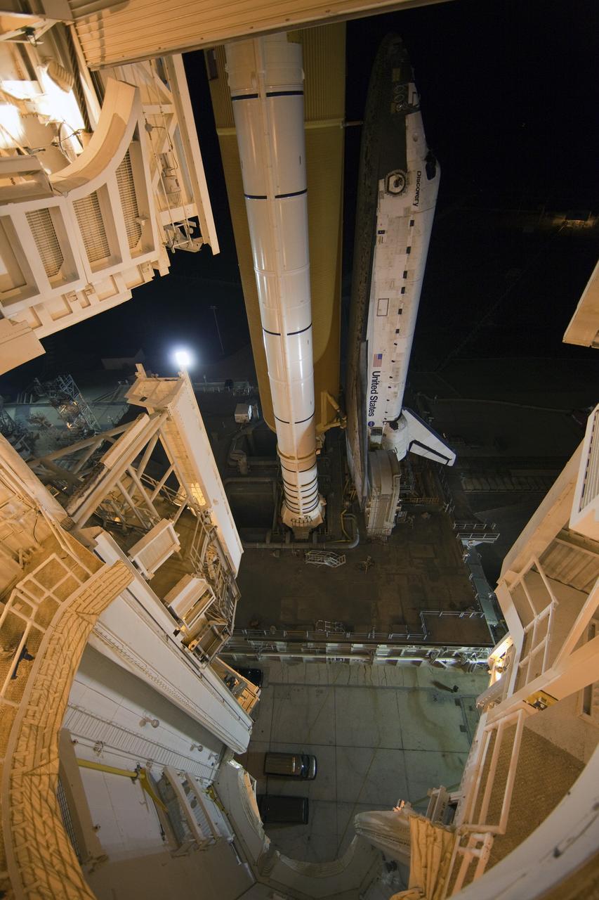 CAPE CANAVERAL, Fla. -- Space shuttle Discovery, secured to a crawler-transporter, slowly moves away from Launch Pad 39A at NASA's Kennedy Space Center in Florida. The 3.4-mile trek, called rollback, to the Vehicle Assembly Building began at 10:48 p.m. and took about eight hours. Next, Discovery's external fuel tank will be examined and foam reapplied where 89 sensors were installed on the tank's aluminum skin for an instrumented tanking test on Dec. 17. The sensors were used to measure changes in the tank as super-cold propellants were pumped in and drained out. Data and analysis from the test will be used to determine what caused the tops of two, 21-foot-long support beams, called stringers, on the outside of the intertank to crack during fueling on Nov. 5.  Discovery's next launch opportunity to the International Space Station on the STS-133 mission is no earlier than Feb. 3, 2011. For more information on STS-133, visit www.nasa.gov/mission_pages/shuttle/shuttlemissions/sts133/. Photo credit: NASA/Frank Michaux