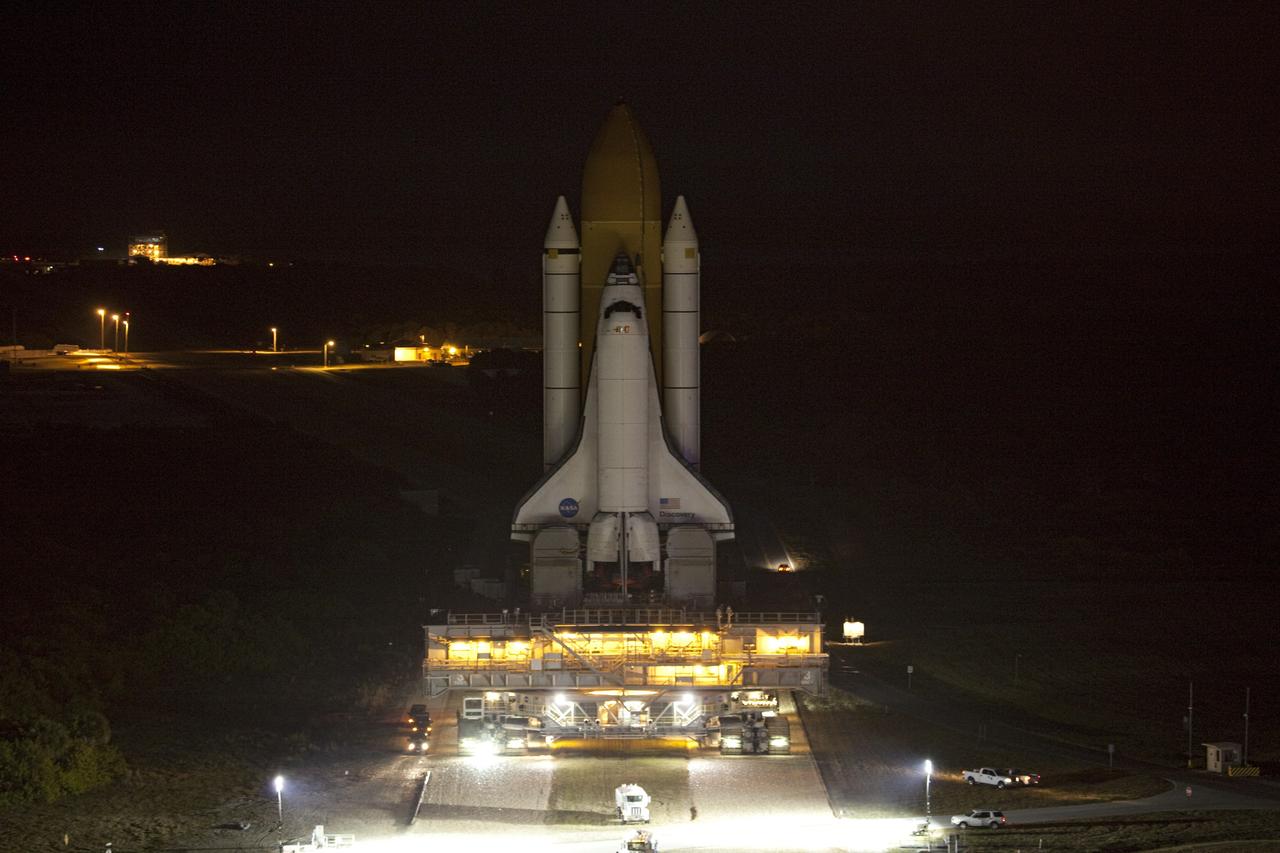 CAPE CANAVERAL, Fla. -- Space shuttle Discovery slowly moves down the crawlerway at NASA's Kennedy Space Center in Florida. The 3.4-mile trek, called rollback, from Launch Pad 39A to the Vehicle Assembly Building began at 10:48 p.m. yesterday and took about eight hours. Next, Discovery's external fuel tank will be examined and foam reapplied where 89 sensors were installed on the tank's aluminum skin for an instrumented tanking test on Dec. 17. The sensors were used to measure changes in the tank as super-cold propellants were pumped in and drained out. Data and analysis from the test will be used to determine what caused the tops of two, 21-foot-long support beams, called stringers, on the outside of the intertank to crack during fueling on Nov. 5.            Discovery's next launch opportunity to the International Space Station on the STS-133 mission is no earlier than Feb. 3, 2011. For more information on STS-133, visit www.nasa.gov/mission_pages/shuttle/shuttlemissions/sts133/. Photo credit: NASA/Frank Michaux