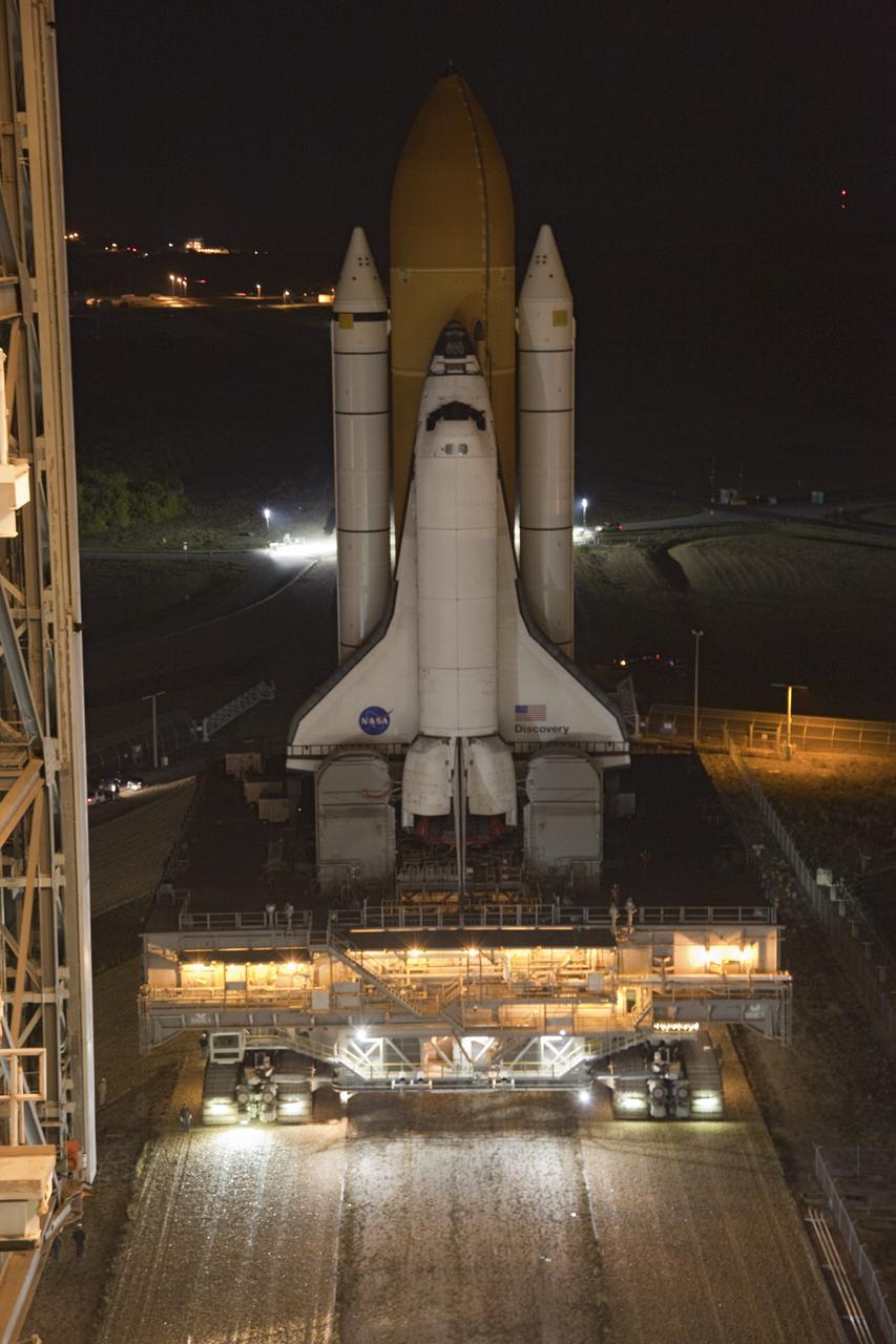 CAPE CANAVERAL, Fla. -- Space shuttle Discovery begins to enter the Vehicle Assembly Building at NASA's Kennedy Space Center in Florida. The 3.4-mile trek, called rollback, from Launch Pad 39A began at 10:48 p.m. yesterday and took about eight hours. Next, Discovery's external fuel tank will be examined and foam reapplied where 89 sensors were installed on the tank's aluminum skin for an instrumented tanking test on Dec. 17. The sensors were used to measure changes in the tank as super-cold propellants were pumped in and drained out. Data and analysis from the test will be used to determine what caused the tops of two, 21-foot-long support beams, called stringers, on the outside of the intertank to crack during fueling on Nov. 5.        Discovery's next launch opportunity to the International Space Station on the STS-133 mission is no earlier than Feb. 3, 2011. For more information on STS-133, visit www.nasa.gov/mission_pages/shuttle/shuttlemissions/sts133/. Photo credit: NASA/Frank Michaux