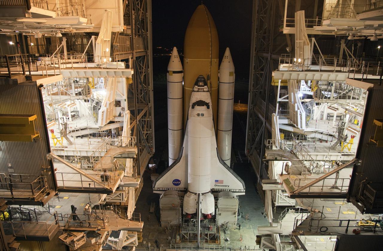 CAPE CANAVERAL, Fla. -- Space shuttle Discovery enters the Vehicle Assembly Building at NASA's Kennedy Space Center in Florida. The 3.4-mile trek, called rollback, from Launch Pad 39A began at 10:48 p.m. yesterday and took about eight hours. Next, Discovery's external fuel tank will be examined and foam reapplied where 89 sensors were installed on the tank's aluminum skin for an instrumented tanking test on Dec. 17. The sensors were used to measure changes in the tank as super-cold propellants were pumped in and drained out. Data and analysis from the test will be used to determine what caused the tops of two, 21-foot-long support beams, called stringers, on the outside of the intertank to crack during fueling on Nov. 5.        Discovery's next launch opportunity to the International Space Station on the STS-133 mission is no earlier than Feb. 3, 2011. For more information on STS-133, visit www.nasa.gov/mission_pages/shuttle/shuttlemissions/sts133/. Photo credit: NASA/Frank Michaux