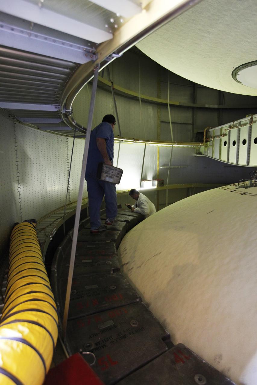 CAPE CANAVERAL, Fla. -- Preparations are under way in the Vehicle Assembly Building at NASA's Kennedy Space Center in Florida to examine space shuttle Discovery's external fuel tank. Shown here, is the inside of the tank's intertank region. Technicians will begin to remove thermal sensors that will give engineers data about the changes the tank went through during the loading and draining of super-cold propellants during a tanking test on Dec. 17. Engineers also will examine 21-foot-long support beams, called stringers, on the outside of the tank's intertank region. Also on the agenda, is to re-apply foam to the outside of the tank. Discovery's next launch opportunity to the International Space Station on the STS-133 mission is no earlier than Feb. 3, 2011. For more information on STS-133, visit www.nasa.gov/mission_pages/shuttle/shuttlemissions/sts133/. Photo credit: NASA/Dimitri Gerondidakis