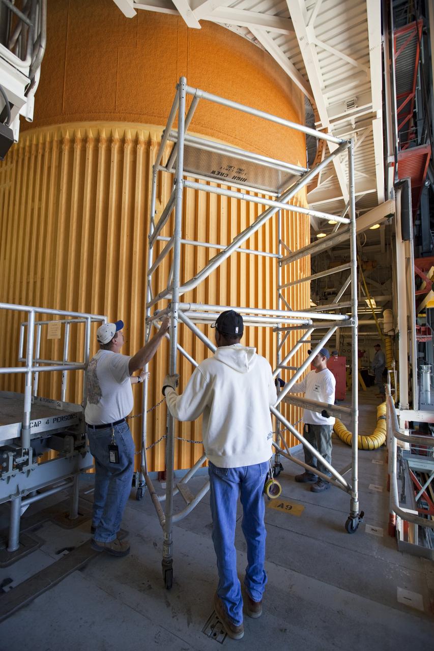 CAPE CANAVERAL, Fla. -- Preparations are under way in the Vehicle Assembly Building at NASA's Kennedy Space Center in Florida to examine space shuttle Discovery's external fuel tank. Technicians will begin to remove thermal sensors that will give engineers data about the changes the tank went through during the loading and draining of super-cold propellants during a tanking test on Dec. 17. Engineers also will examine 21-foot-long support beams, called stringers, on the outside of the tank's intertank region. Also on the agenda, is to re-apply foam to the outside of the tank. Discovery's next launch opportunity to the International Space Station on the STS-133 mission is no earlier than Feb. 3, 2011. For more information on STS-133, visit www.nasa.gov/mission_pages/shuttle/shuttlemissions/sts133/. Photo credit: NASA/Dimitri Gerondidakis