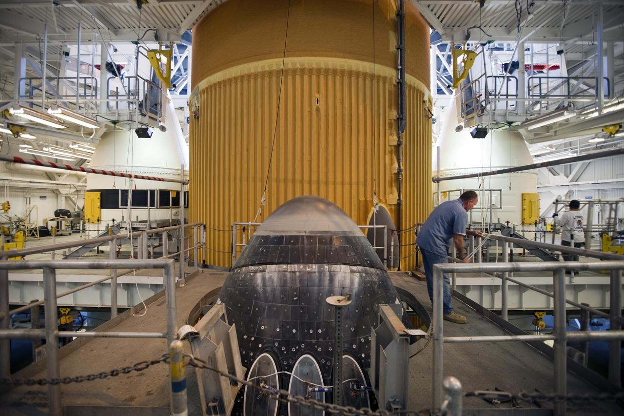 CAPE CANAVERAL, Fla. -- Preparations are under way in the Vehicle Assembly Building at NASA's Kennedy Space Center in Florida to examine space shuttle Discovery's external fuel tank. Shown here is the nose of the shuttle, which still is attached to the external tank and solid rocket boosters. Technicians will begin to remove thermal sensors that will give engineers data about the changes the tank went through during the loading and draining of super-cold propellants during a tanking test on Dec. 17. Engineers also will examine 21-foot-long support beams, called stringers, on the outside of the tank's intertank region. Also on the agenda, is to re-apply foam to the outside of the tank. Discovery's next launch opportunity to the International Space Station on the STS-133 mission is no earlier than Feb. 3, 2011. For more information on STS-133, visit www.nasa.gov/mission_pages/shuttle/shuttlemissions/sts133/. Photo credit: NASA/Dimitri Gerondidakis