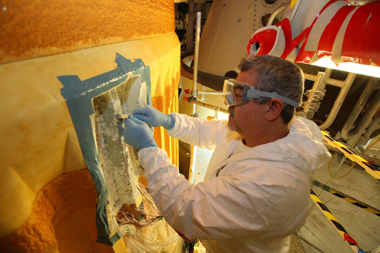 CAPE CANAVERAL, Fla. -- Technician will remove thermal sensors and foam insulation from space shuttle Discovery's external fuel tank in the Vehicle Assembly Building. The sensors will give engineers data about the changes the tank went through with the loading and draining of super-cold propellants during a tanking test on Dec. 17.       Discovery's next launch opportunity to the International Space Station on the STS-133 mission is no earlier than Feb. 3, 2011. For more information on STS-133, visit www.nasa.gov/mission_pages/shuttle/shuttlemissions/sts133/. Photo credit: NASA/Frank Michaux