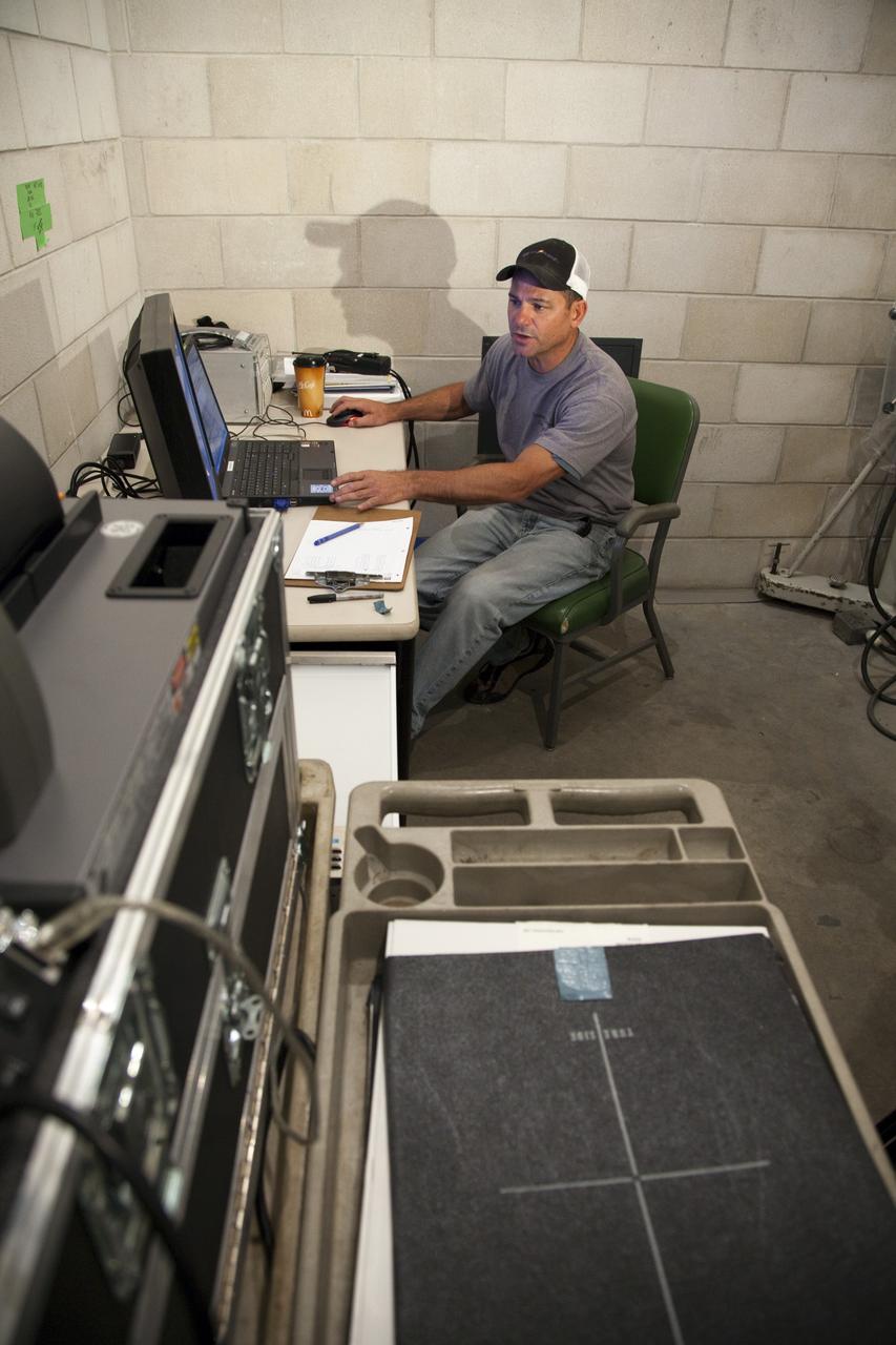CAPE CANAVERAL, Fla. -- A technician prepares to monitor computed radiography scans of space shuttle Discovery's external fuel tank. The shuttle stack, consisting of the shuttle, external tank and solid rocket boosters, was moved from Launch Pad 39A to the Vehicle Assembly Building at NASA's Kennedy Space Center in Florida so technicians could examine 21-foot-long support beams, called stringers, on the outside of the tank's intertank and re-apply foam insulation. Discovery's next launch opportunity to the International Space Station on the STS-133 mission is no earlier than Feb. 3, 2011. For more information on STS-133, visit www.nasa.gov/mission_pages/shuttle/shuttlemissions/sts133/. Photo credit: NASA/Frankie Martin