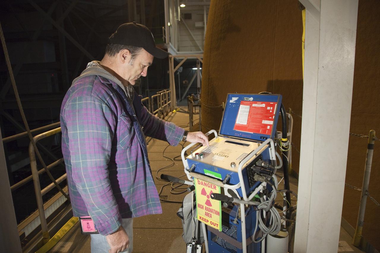 CAPE CANAVERAL, Fla. -- A technician takes computed radiography scans of space shuttle Discovery's external fuel tank. The shuttle stack, consisting of the shuttle, external tank and solid rocket boosters, was moved from Launch Pad 39A to the Vehicle Assembly Building at NASA's Kennedy Space Center in Florida so technicians could examine 21-foot-long support beams, called stringers, on the outside of the tank's intertank and re-apply foam insulation. Discovery's next launch opportunity to the International Space Station on the STS-133 mission is no earlier than Feb. 3, 2011. For more information on STS-133, visit www.nasa.gov/mission_pages/shuttle/shuttlemissions/sts133/. Photo credit: NASA/Frankie Martin