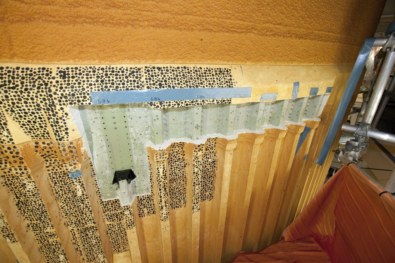 CAPE CANAVERAL, Fla. -- Repair work to space shuttle Discovery's external fuel tank begins in the Vehicle Assembly Building at NASA's Kennedy Space Center in Florida. Technicians will modify 32 support beams, called stringers, on the tank's intertank region by fitting pieces of metal, called radius blocks, over the stringers' edges where they attach to the thrust panel area. The thrust panel is where the tank meets the two solid rocket boosters and sees the most stress during the flight into orbit. After the modifications and additional scans of the stringers are complete, foam insulation will be re-applied. Discovery's next launch opportunity to the International Space Station on the STS-133 mission is no earlier than Feb. 3, 2011. For more information on STS-133, visit www.nasa.gov/mission_pages/shuttle/shuttlemissions/sts133/. Photo credit: NASA/Jack Pfaller