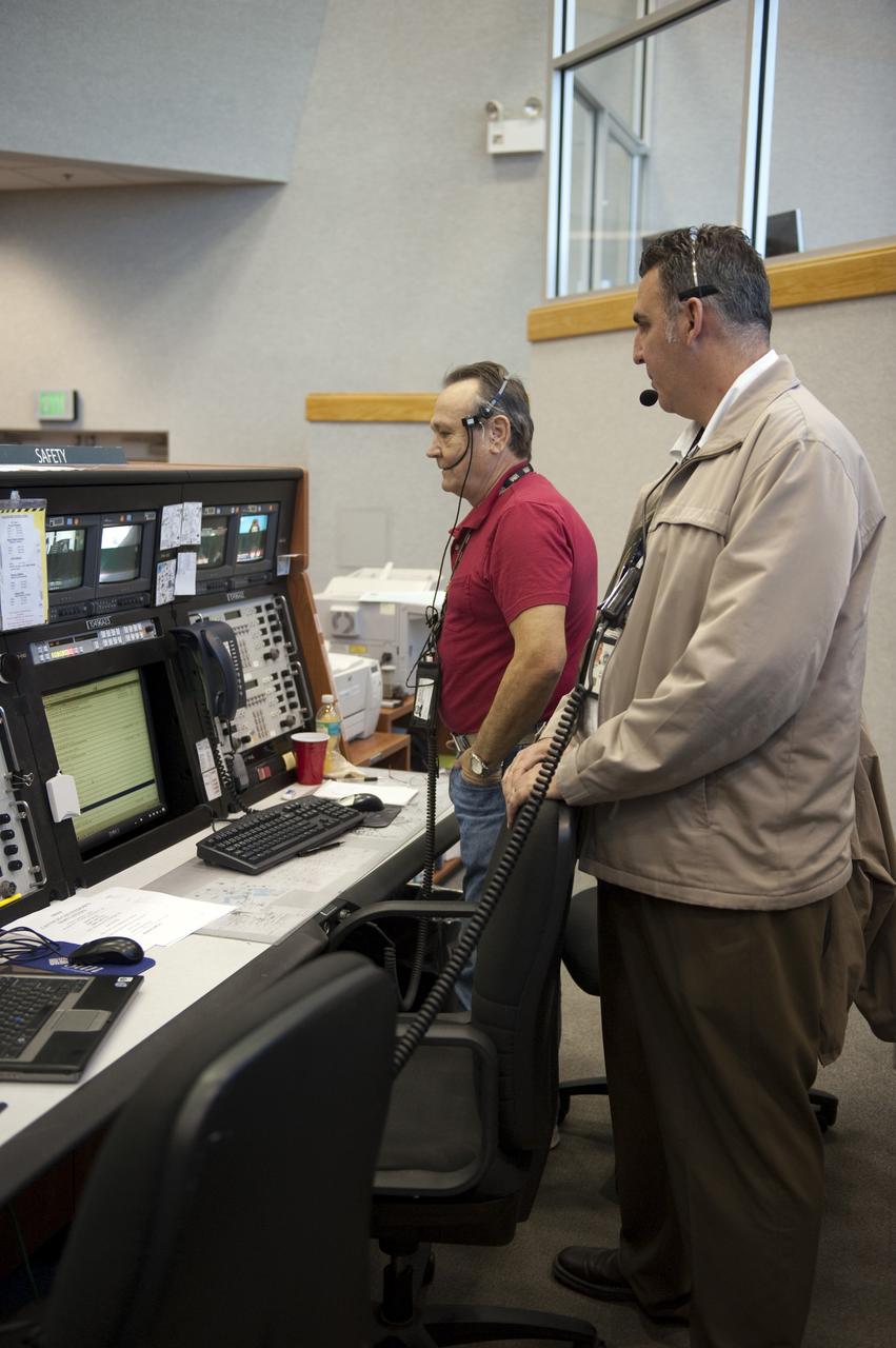 CAPE CANAVERAL, Fla. -- In the Launch Control Center at NASA's Kennedy Space Center in Florida, United Space Alliance Safety Engineer Dwayne Thompson, left, and NASA Safety Engineer Dallas McCarter rehearse procedures for the liftoff of space shuttle Discovery's final mission with other STS-133 launch team members in Firing Room 4. The team at Kennedy also participated in launch simulations with personnel at NASA's Johnson Space Center in Houston. Discovery's next launch opportunity to the International Space Station on the STS-133 mission is planned for no earlier than Feb. 24. For more information on STS-133, visit www.nasa.gov/mission_pages/shuttle/shuttlemissions/sts133/. Photo credit: NASA/Kim Shiflett
