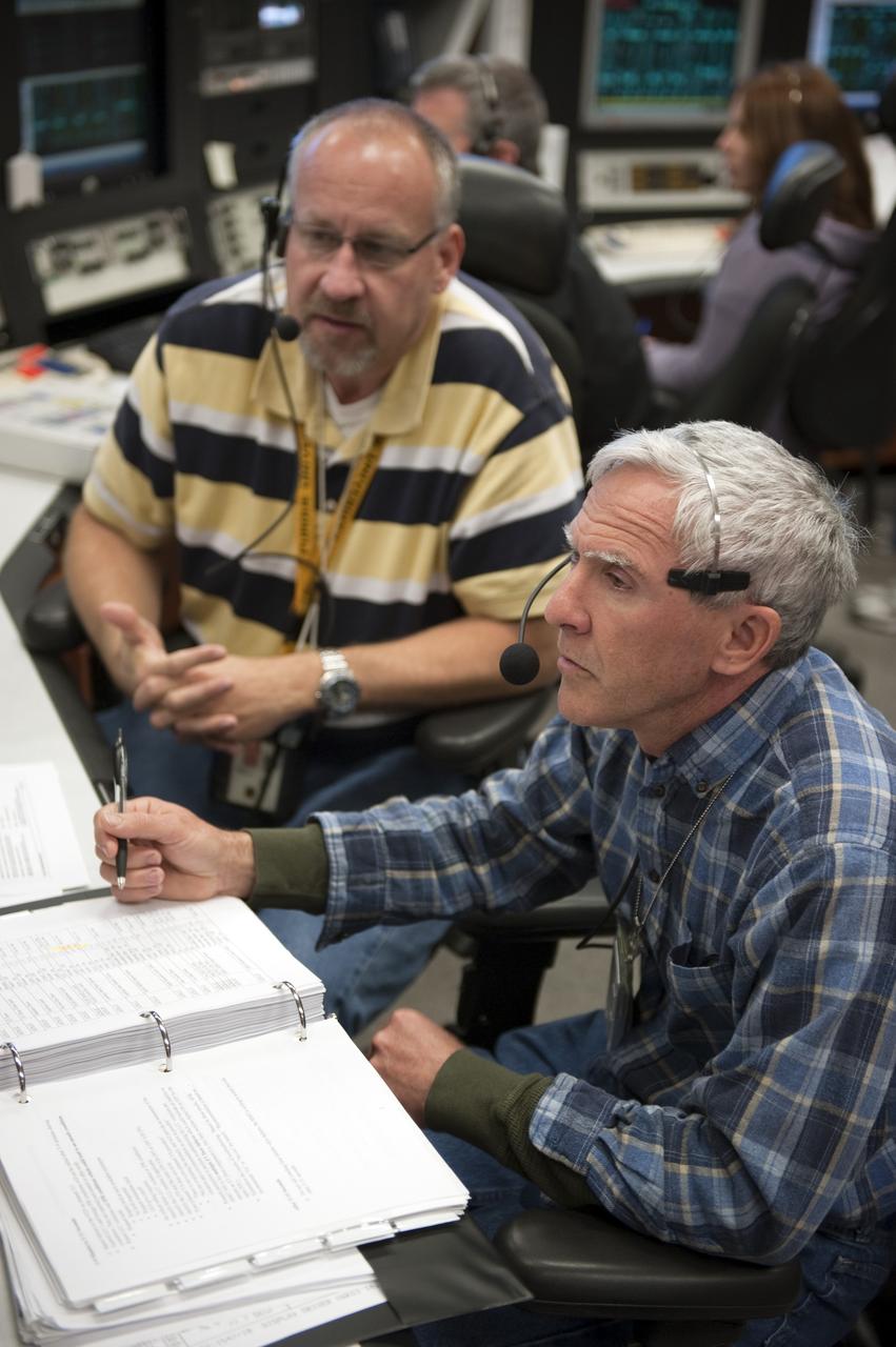 CAPE CANAVERAL, Fla. -- In the Launch Control Center at NASA's Kennedy Space Center in Florida, Mechanisms/Orbiter Handling Engineer Rob Lantz, left, and United Space Alliance Remote Manipulator System Engineer Paul Hofmeister, rehearse procedures for the liftoff of space shuttle Discovery's final mission with other STS-133 launch team members in Firing Room 4. The team at Kennedy also participated in launch simulations with personnel at NASA's Johnson Space Center in Houston. Discovery's next launch opportunity to the International Space Station on the STS-133 mission is planned for no earlier than Feb. 24. For more information on STS-133, visit www.nasa.gov/mission_pages/shuttle/shuttlemissions/sts133/. Photo credit: NASA/Kim Shiflett