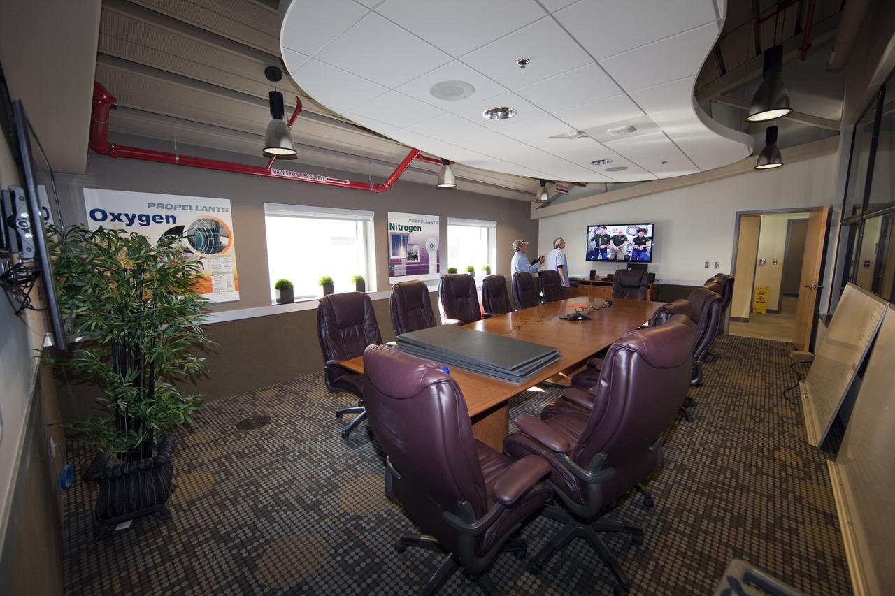 CAPE CANAVERAL, Fla. -- Finishing touches adorn the second-floor conference room of the Propellants North Administrative and Maintenance Facility at NASA's Kennedy Space Center in Florida. The environmentally friendly facility is slated to be NASA's second Platinum-rated by the U.S. Green Building Council's (USGBC) Leadership in Environmental and Energy Design (LEED) certification system. It will be the space agency's first net-zero facility, which means it will produce enough energy onsite from renewable sources to offset what it requires to operate. The facility consists of a two-story administrative building to house managers, mechanics and technicians who fuel spacecraft at Kennedy, and a single-story shop to store cryogenic fuel transfer equipment. Photo credit: NASA/Frankie Martin