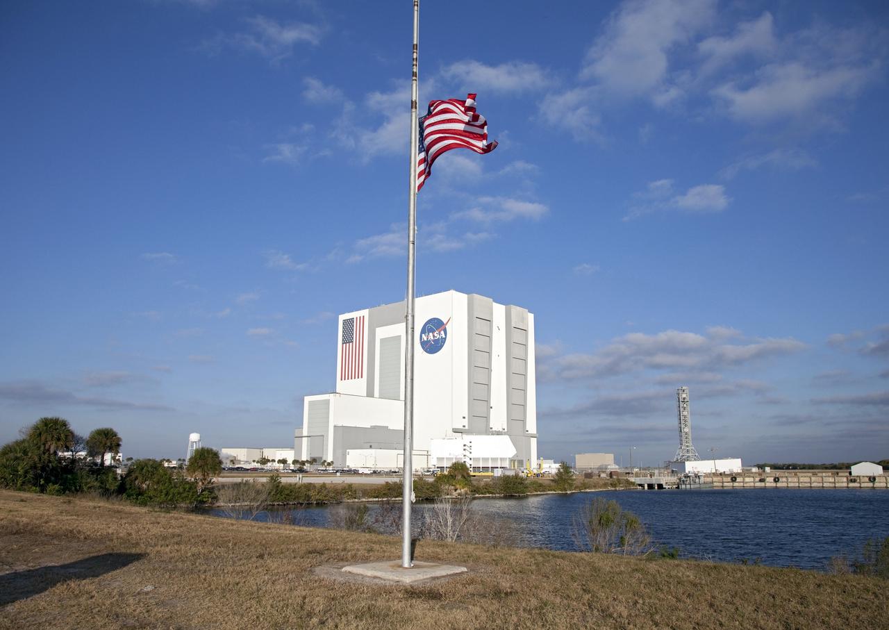 CAPE CANAVERAL, Fla. -- In accordance with a Presidential Proclamation, the American Flag in the Launch Complex 39 area of NASA's Kennedy Space Center in Florida flies at half-staff to honor U.S. Rep. Gabrielle Giffords and others who were wounded or killed during a shooting spree in Tucson, Arizona. This flag and all American Flags at U.S. military and government installations across the country and abroad will remain at half-staff until sunset on Jan. 14. Giffords is the wife of NASA astronaut Mark Kelly, who is scheduled to command space shuttle Endeavour's last mission, STS-134, to the International Space Station later this year.          Photo credit: NASA/Frankie Martin