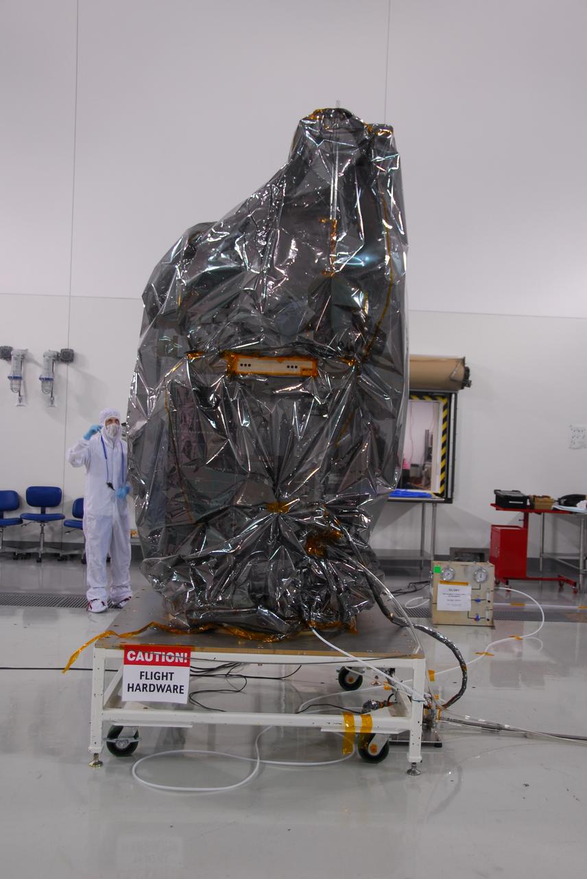 VANDENBERG AIR FORCE BASE, Calif. -- Inside the Astrotech payload processing facility at Vandenberg Air Force Base in California, NASA's Glory spacecraft will be removed from its protective covering. Next, the spacecraft will be encapsulated in its protective payload fairing before it is transported to Space Launch Complex 576-E and joined with the Taurus XL rocket's third stage. Once Glory reaches orbit, it will collect data on the properties of aerosols and black carbon. It also will help scientists understand how the sun's irradiance affects Earth's climate. Launch is scheduled for 5:09 a.m. EST Feb. 23. For information, visit www.nasa.gov/glory. Photo credit: NASA/Ed Henry, VAFB