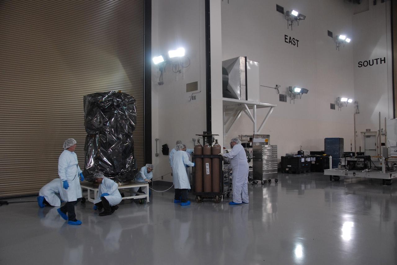VANDENBERG AIR FORCE BASE, Calif. -- Inside the Astrotech processing facility at Vandenberg Air Force Base in California, NASA's Glory spacecraft is situated on a dolly and ready for processing.  Next, technicians will take off Glory's protective covering before it is encapsulated in a protective payload fairing for flight. In early February, Glory is scheduled to be transported Space Launch Complex 576-E where it will be joined with the Taurus XL rocket, which is manufactured by Orbital Sciences Corp.      Once Glory reaches orbit, it will collect data on the properties of aerosols and black carbon. It also will help scientists understand how the sun's irradiance affects Earth's climate. Launch is scheduled for 5:09 a.m. EST Feb. 23. For information, visit www.nasa.gov/glory. Photo credit: NASA/Ed Henry, VAFB