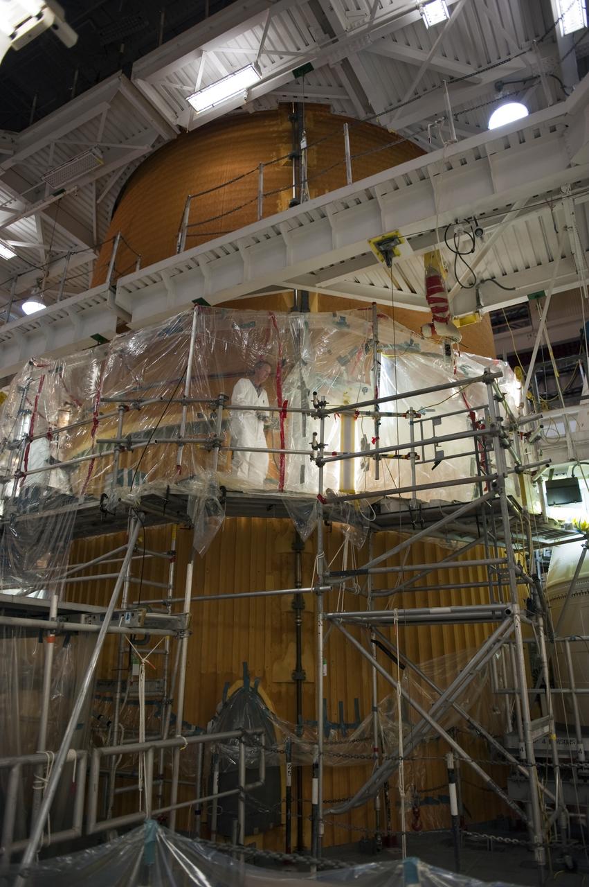CAPE CANAVERAL, Fla. -- Repair work to space shuttle Discovery's external fuel tank continues in the Vehicle Assembly Building at NASA's Kennedy Space Center in Florida. Technicians are modifying 94 support beams, called stringers, on the tank's intertank region by fitting pieces of metal, called radius blocks, over the stringers' edges. After the modifications of the stringers are complete, foam insulation will be re-applied to the tank. Discovery's next launch opportunity to the International Space Station on the STS-133 mission is targeted for Feb. 24, 2011. For more information on STS-133, visit www.nasa.gov/mission_pages/shuttle/shuttlemissions/sts133/. Photo credit: NASA/Kim Shiflett