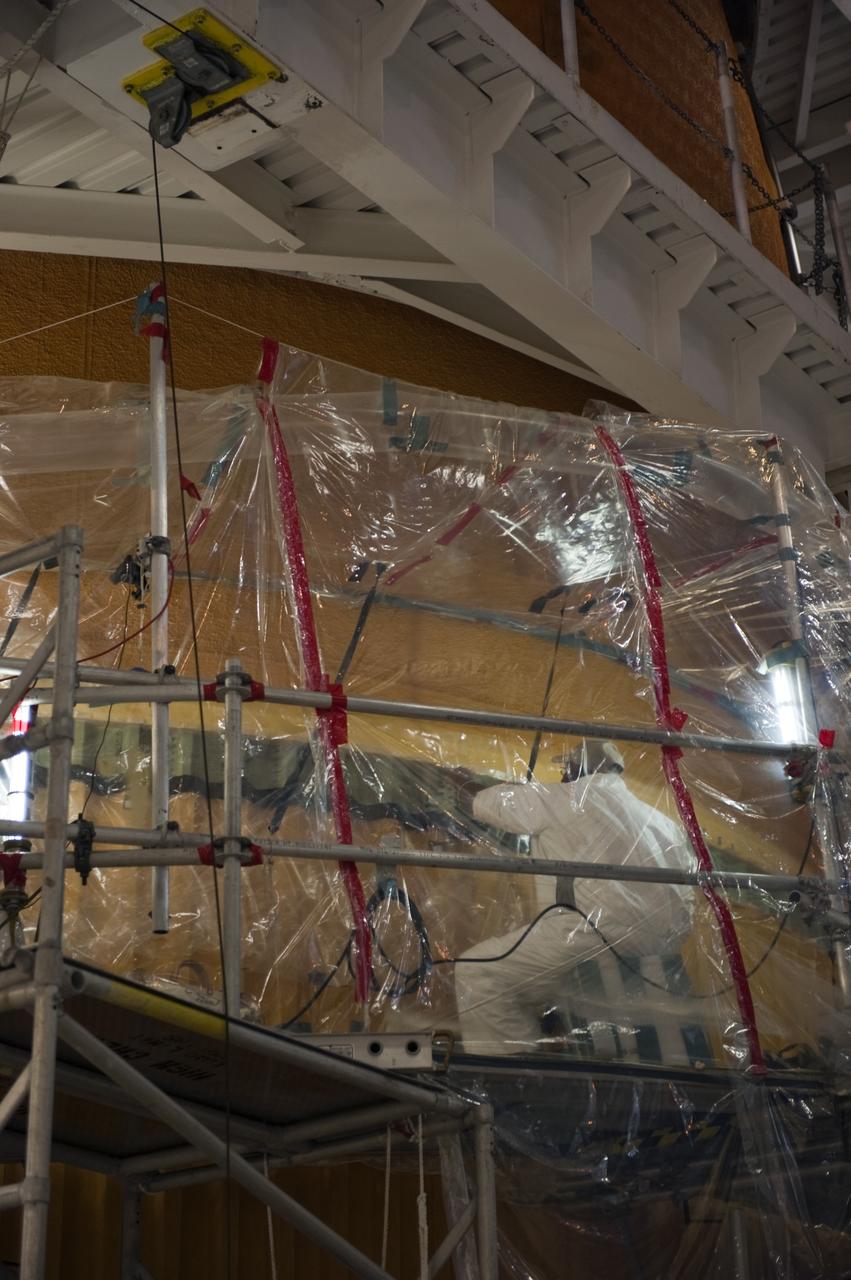 CAPE CANAVERAL, Fla. -- Repair work to space shuttle Discovery's external fuel tank continues in the Vehicle Assembly Building at NASA's Kennedy Space Center in Florida. Technicians are modifying 94 support beams, called stringers, on the tank's intertank region by fitting pieces of metal, called radius blocks, over the stringers' edges. After the modifications of the stringers are complete, foam insulation will be re-applied to the tank. Discovery's next launch opportunity to the International Space Station on the STS-133 mission is targeted for Feb. 24, 2011. For more information on STS-133, visit www.nasa.gov/mission_pages/shuttle/shuttlemissions/sts133/. Photo credit: NASA/Kim Shiflett