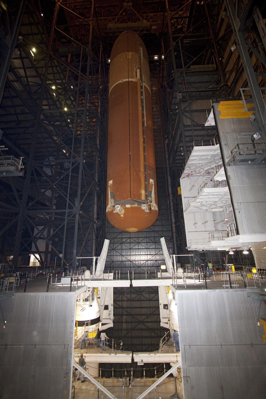 CAPE CANAVERAL, Fla. -- In the Vehicle Assembly Building at NASA's Kennedy Space Center in Florida, technicians watch external fuel tank, ET-122, for space shuttle Endeavour's STS-134 mission as it is being lowered toward the twin solid rocket boosters. When in place the tank will be attached to the boosters on the mobile launcher platform. Endeavour and its crew will deliver the Express Logistics Carrier-3 and the Alpha Magnetic Spectrometer to the International Space Station. Launch is targeted for April 19. For more information visit, http://www.nasa.gov/mission_pages/shuttle/shuttlemissions/sts134/index.html. Photo credit: NASA/Jack Pfaller
