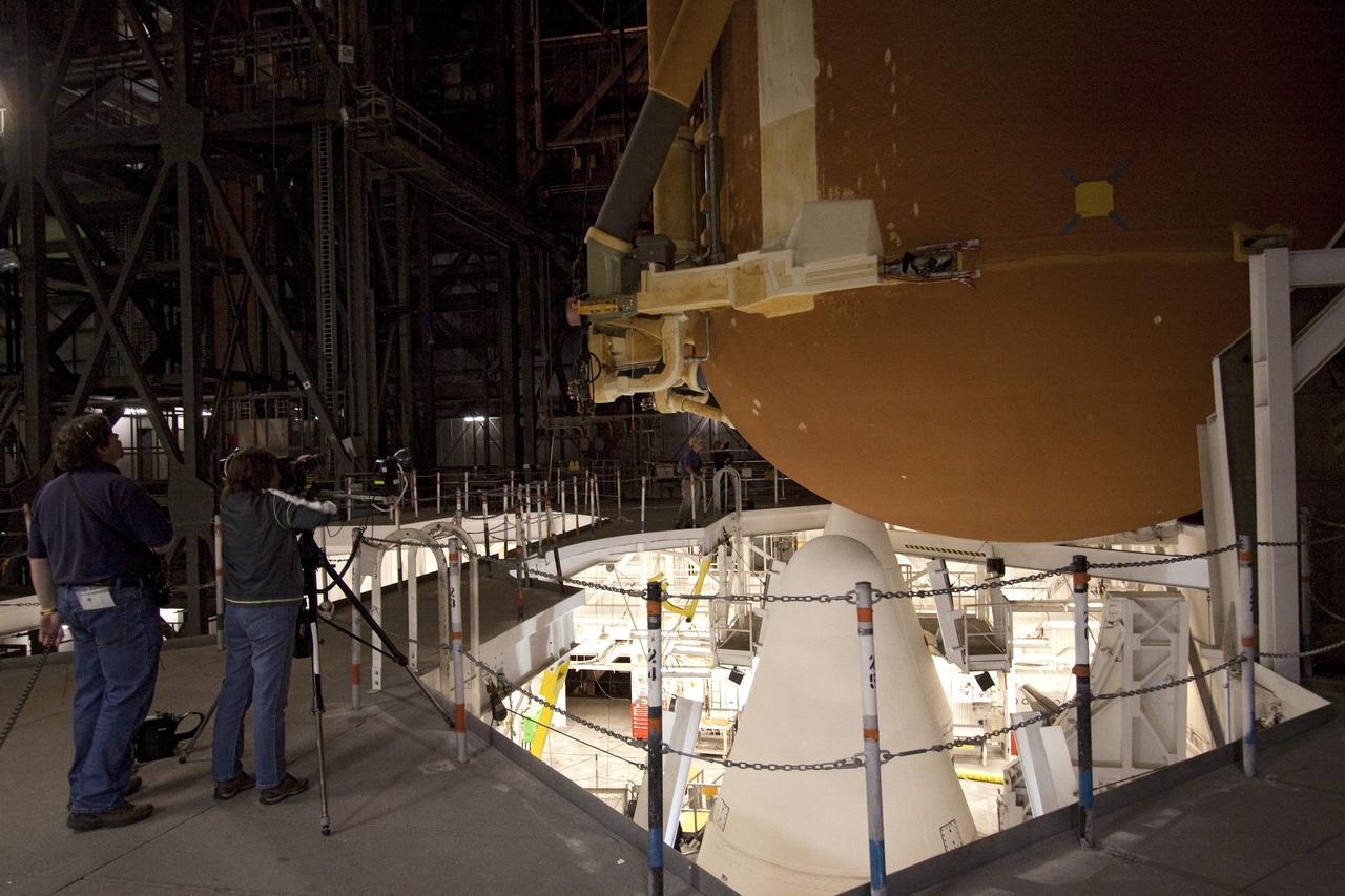 CAPE CANAVERAL, Fla. -- In the Vehicle Assembly Building at NASA's Kennedy Space Center in Florida, workers closely monitor the progress of external fuel tank, ET-122, for space shuttle Endeavour's STS-134 mission as it is being lowered toward the twin solid rocket boosters. When in place the tank will be attached to the boosters on the mobile launcher platform. Endeavour and its crew will deliver the Express Logistics Carrier-3 and the Alpha Magnetic Spectrometer to the International Space Station. Launch is targeted for April 19. For more information visit, http://www.nasa.gov/mission_pages/shuttle/shuttlemissions/sts134/index.html. Photo credit: NASA/Jack Pfaller