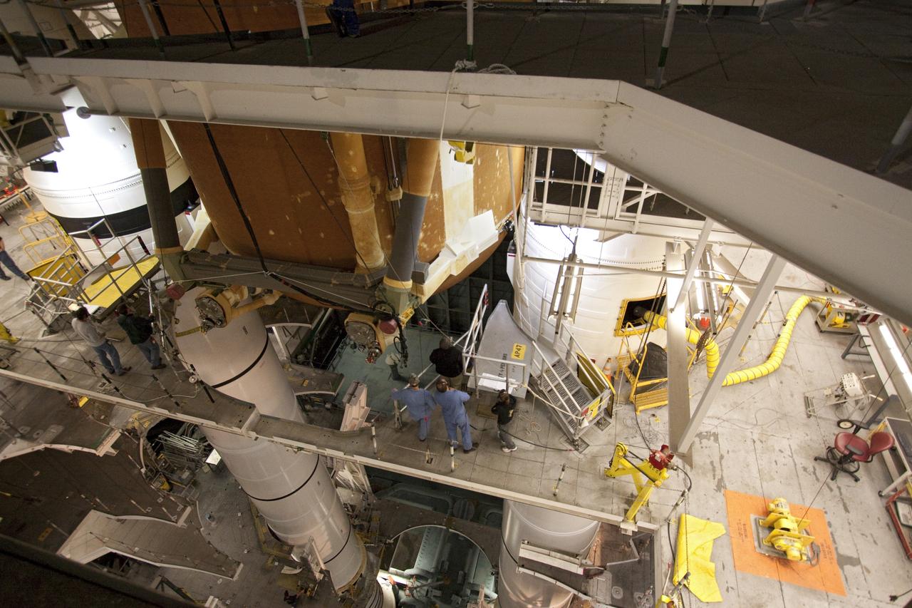 CAPE CANAVERAL, Fla. -- In the Vehicle Assembly Building at NASA's Kennedy Space Center in Florida, technicians watch external fuel tank, ET-122, for space shuttle Endeavour's STS-134 mission as it is being lowered toward the twin solid rocket boosters. When in place the tank will be attached to the boosters on the mobile launcher platform. Endeavour and its crew will deliver the Express Logistics Carrier-3 and the Alpha Magnetic Spectrometer to the International Space Station. Launch is targeted for April 19. For more information visit, http://www.nasa.gov/mission_pages/shuttle/shuttlemissions/sts134/index.html. Photo credit: NASA/Jack Pfaller
