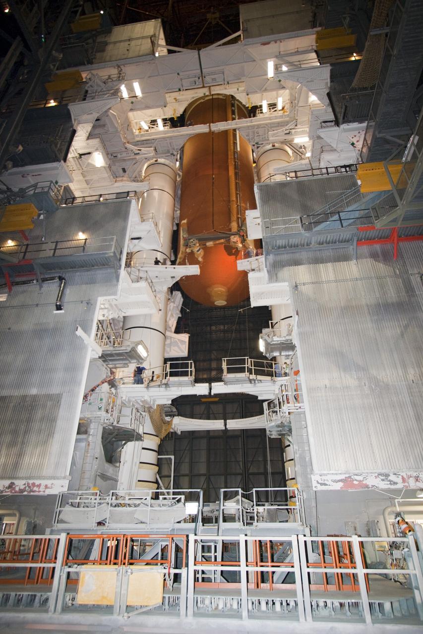 CAPE CANAVERAL, Fla. -- In the Vehicle Assembly Building at NASA's Kennedy Space Center in Florida, technicians watch external fuel tank, ET-122, for space shuttle Endeavour's STS-134 mission as it is being lowered toward the twin solid rocket boosters. When in place the tank will be attached to the boosters on the mobile launcher platform. Endeavour and its crew will deliver the Express Logistics Carrier-3 and the Alpha Magnetic Spectrometer to the International Space Station. Launch is targeted for April 19. For more information visit, http://www.nasa.gov/mission_pages/shuttle/shuttlemissions/sts134/index.html. Photo credit: NASA/Jack Pfaller