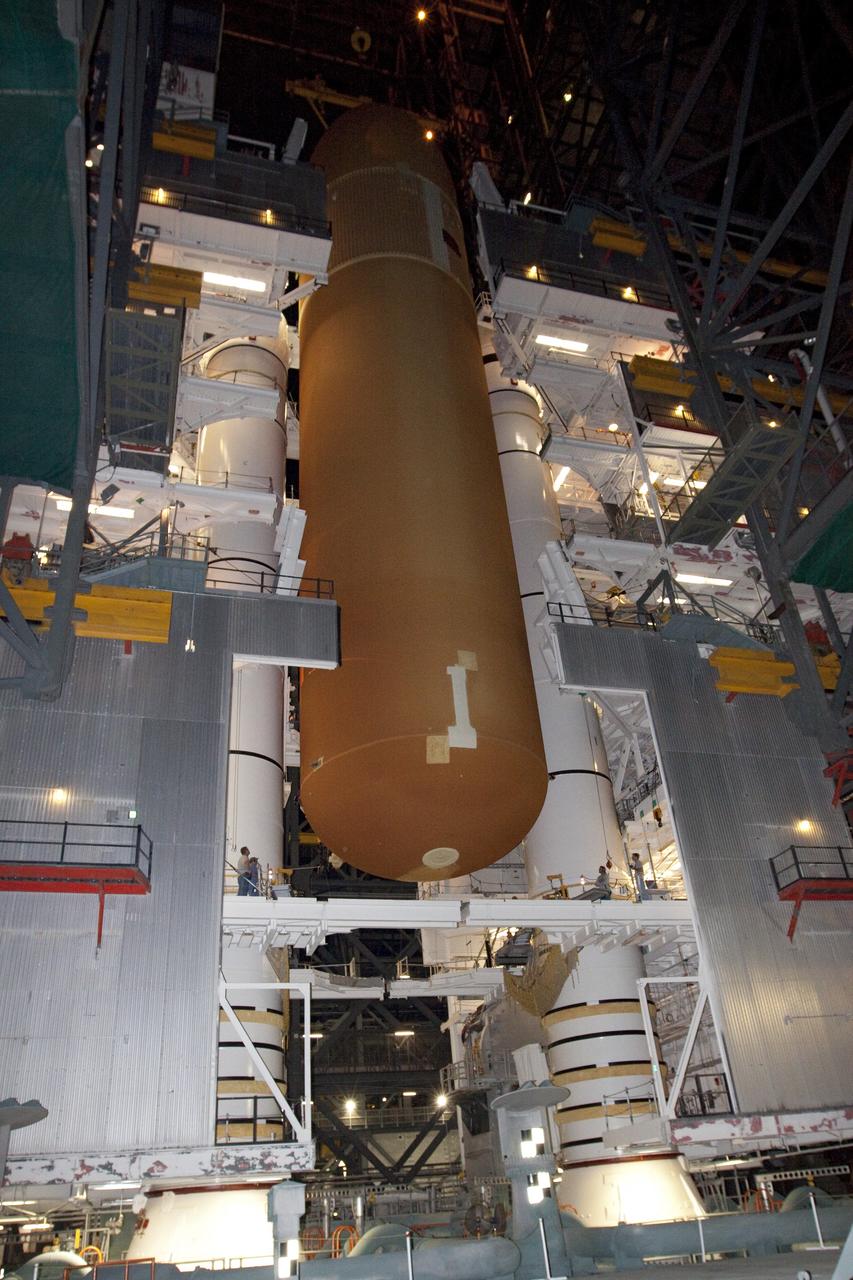 CAPE CANAVERAL, Fla. -- In the Vehicle Assembly Building at NASA's Kennedy Space Center in Florida, workers monitor the progress of external fuel tank, ET-122, for space shuttle Endeavour's STS-134 mission as it is being attached to the twin solid rocket boosters on the mobile launcher platform.            Endeavour and its crew will deliver the Express Logistics Carrier-3 and the Alpha Magnetic Spectrometer to the International Space Station. Launch is targeted for April 19. For more information visit, http://www.nasa.gov/mission_pages/shuttle/shuttlemissions/sts134/index.html. Photo credit: NASA/Jack Pfaller