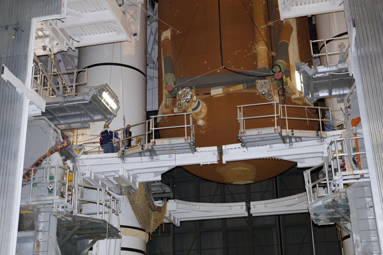 CAPE CANAVERAL, Fla. -- In the Vehicle Assembly Building at NASA's Kennedy Space Center in Florida, workers monitor the progress of external fuel tank, ET-122, for space shuttle Endeavour's STS-134 mission as it is being attached to the twin solid rocket boosters on the mobile launcher platform.            Endeavour and its crew will deliver the Express Logistics Carrier-3 and the Alpha Magnetic Spectrometer to the International Space Station. Launch is targeted for April 19. For more information visit, http://www.nasa.gov/mission_pages/shuttle/shuttlemissions/sts134/index.html. Photo credit: NASA/Jack Pfaller