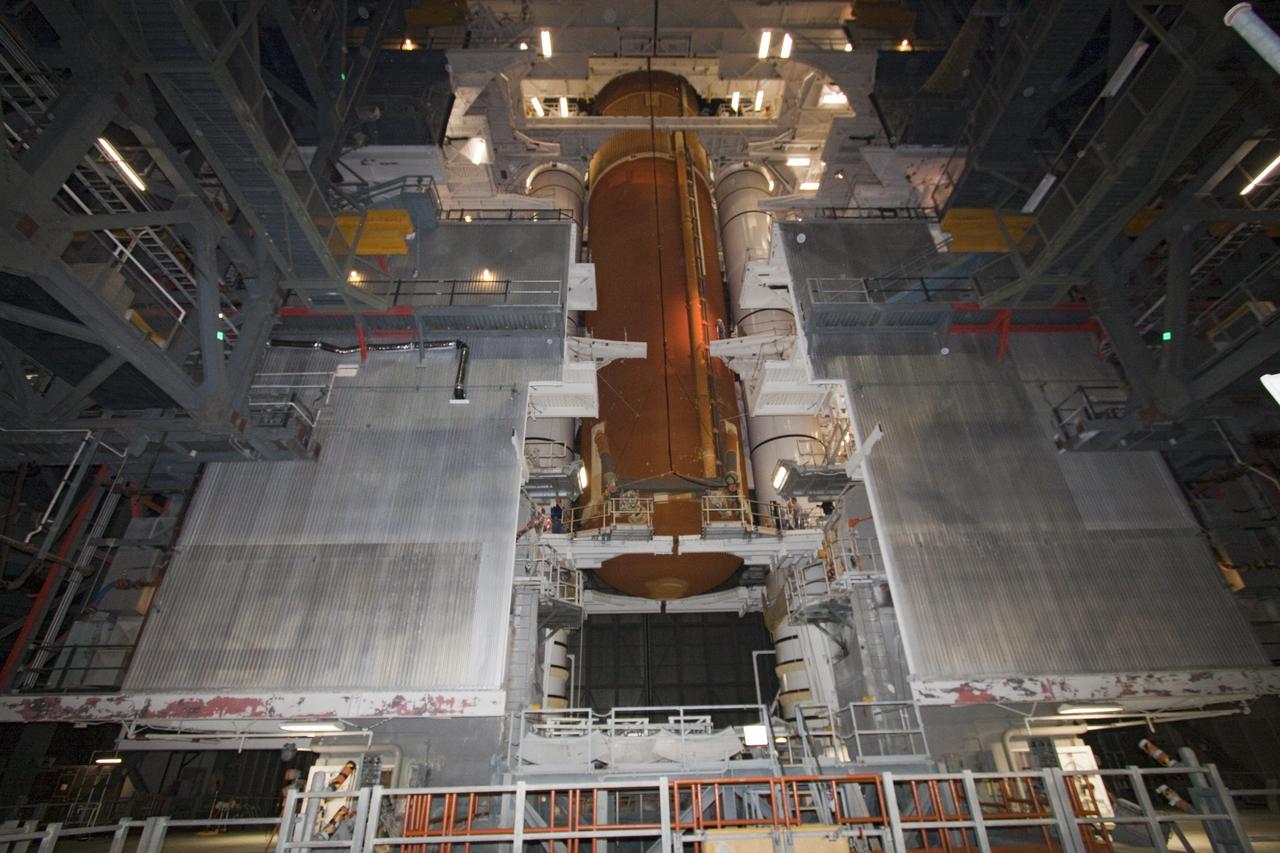 CAPE CANAVERAL, Fla. -- In the Vehicle Assembly Building at NASA's Kennedy Space Center in Florida, workers monitor the progress of external fuel tank, ET-122, for space shuttle Endeavour's STS-134 mission as it is being attached to the twin solid rocket boosters on the mobile launcher platform.            Endeavour and its crew will deliver the Express Logistics Carrier-3 and the Alpha Magnetic Spectrometer to the International Space Station. Launch is targeted for April 19. For more information visit, http://www.nasa.gov/mission_pages/shuttle/shuttlemissions/sts134/index.html. Photo credit: NASA/Jack Pfaller