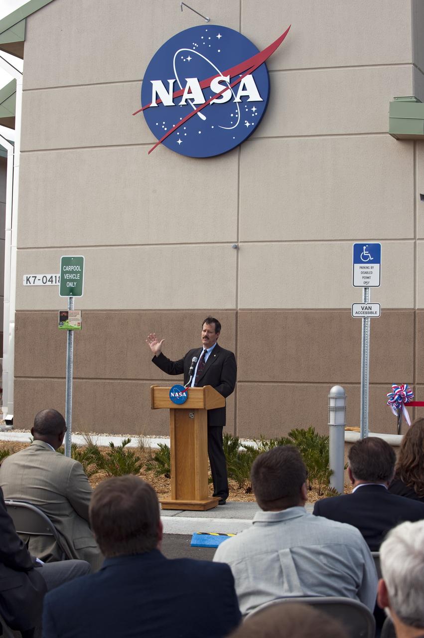 CAPE CANAVERAL, Fla. -- Mike Benik, the director of Center Operations at NASA's Kennedy Space Center in Florida, addresses an audience at the ribbon-cutting ceremony for the new environmentally friendly Propellants North Administration and Maintenance Facility. Propellants North consists of two buildings, one to store cryogenic fuel transfer equipment and one to house personnel who support fueling spacecraft. The recently rebuilt buildings will be NASA's first carbon neutral facility, which means it will produce enough energy on site from renewable sources to offset what it requires to operate. The facility also will reach for the U.S. Green Building Council's Leadership in Environmental and Energy Design (LEED) Platinum status, which is the highest LEED rating. Photo credit: NASA/Kim Shiflett