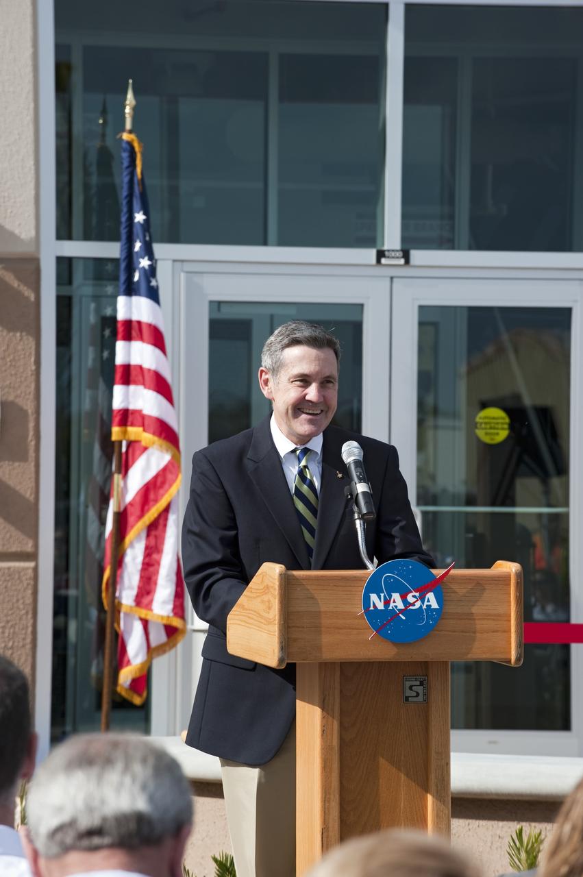 CAPE CANAVERAL, Fla. -- The director of NASA's Kennedy Space Center in Florida, Bob Cabana, addresses an audience at the ribbon-cutting ceremony for the new environmentally friendly Propellants North Administration and Maintenance Facility.    Propellants North consists of two buildings, one to store cryogenic fuel transfer equipment and one to house personnel who support fueling spacecraft. The recently rebuilt buildings will be NASA's first carbon neutral facility, which means it will produce enough energy on site from renewable sources to offset what it requires to operate. The facility also will reach for the U.S. Green Building Council's Leadership in Environmental and Energy Design (LEED) Platinum status, which is the highest LEED rating. Photo credit: NASA/Kim Shiflett