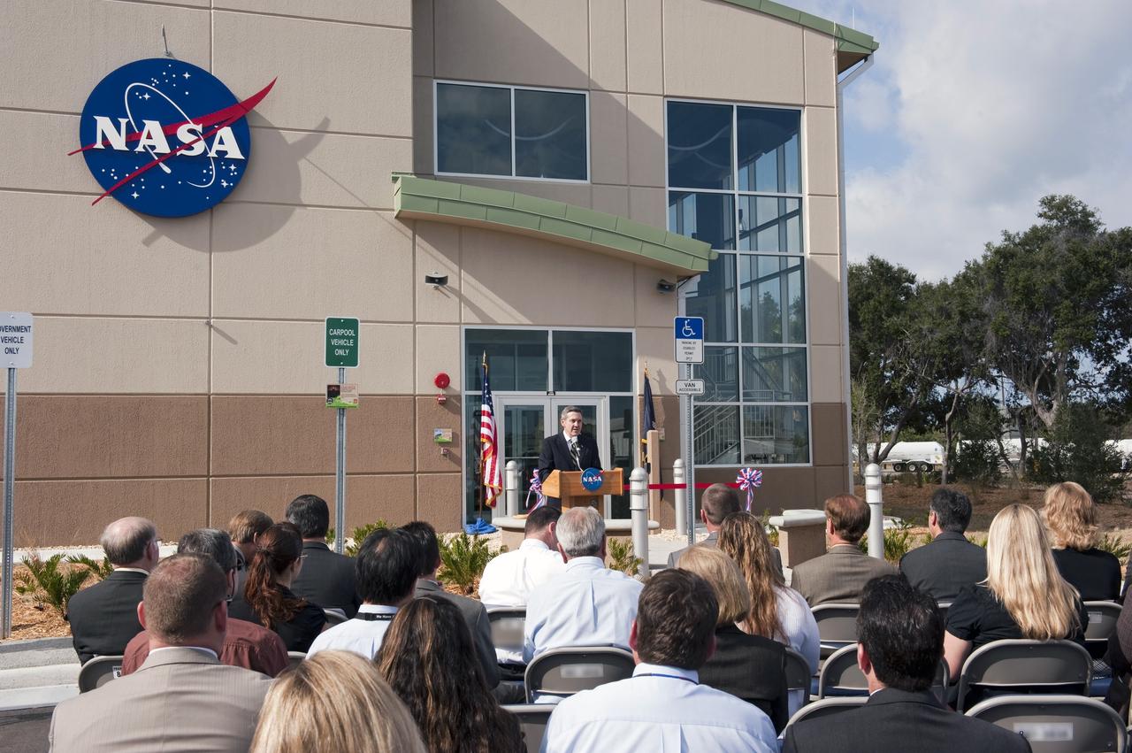 CAPE CANAVERAL, Fla. -- The director of NASA's Kennedy Space Center in Florida, Bob Cabana, addresses an audience at the ribbon-cutting ceremony for the new environmentally friendly Propellants North Administration and Maintenance Facility. Propellants North consists of two buildings, one to store cryogenic fuel transfer equipment and one to house personnel who support fueling spacecraft. The recently rebuilt buildings will be NASA's first carbon neutral facility, which means it will produce enough energy on site from renewable sources to offset what it requires to operate. The facility also will reach for the U.S. Green Building Council's Leadership in Environmental and Energy Design (LEED) Platinum status, which is the highest LEED rating. Photo credit: NASA/Kim Shiflett