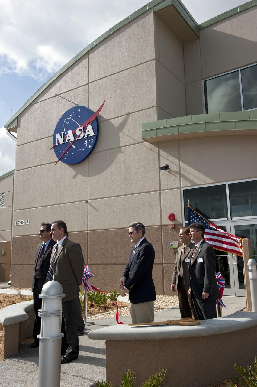 CAPE CANAVERAL, Fla. -- NASA's Kennedy Space Center in Florida hosts a ribbon-cutting ceremony for the space agency's most environmentally friendly facility, the Propellants North Administrative and Maintenance Facility in Kennedy's Launch Complex 39 area. From left, are Mike Benik, director of Kennedy's Center Operations; James Wright, deputy assistant administrator for the Office of Strategic Infrastructure at NASA Headquarters; Bob Cabana, Kennedy's center director; Ward Davis, president of HW Davis Construction Inc.; and Rick Ferreira, chief operating officer of Jones Edmunds and Associates Inc. Propellants North consists of two buildings, one to store cryogenic fuel transfer equipment and one to house personnel who support fueling spacecraft. The recently rebuilt buildings will be NASA's first carbon neutral facility, which means it will produce enough energy on site from renewable sources to offset what it requires to operate. The facility also will reach for the U.S. Green Building Council's Leadership in Environmental and Energy Design (LEED) Platinum status, which is the highest LEED rating. Photo credit: NASA/Kim Shiflett