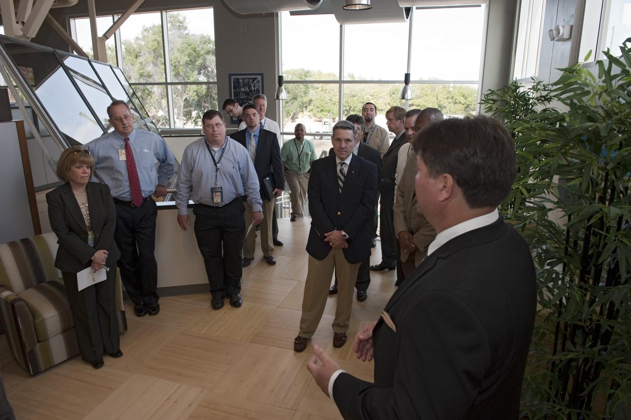 CAPE CANAVERAL, Fla. -- Frank Kline, Construction of Facilities project manager at NASA's Kennedy Space Center in Florida, far right, shows off the environmentally friendly features of the new Propellants North Administration and Maintenance Facility. Propellants North consists of two buildings, one to store cryogenic fuel transfer equipment and one to house personnel who support fueling spacecraft. The recently rebuilt buildings will be NASA's first carbon neutral facility, which means it will produce enough energy on site from renewable sources to offset what it requires to operate. The facility also will reach for the U.S. Green Building Council's Leadership in Environmental and Energy Design (LEED) Platinum status, which is the highest LEED rating. Photo credit: NASA/Kim Shiflett