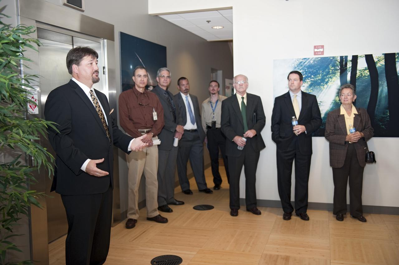 CAPE CANAVERAL, Fla. -- Frank Kline, Construction of Facilities project manager at NASA's Kennedy Space Center in Florida, far left, shows off the environmentally friendly features of the new Propellants North Administration and Maintenance Facility. Propellants North consists of two buildings, one to store cryogenic fuel transfer equipment and one to house personnel who support fueling spacecraft. The recently rebuilt buildings will be NASA's first carbon neutral facility, which means it will produce enough energy on site from renewable sources to offset what it requires to operate. The facility also will reach for the U.S. Green Building Council's Leadership in Environmental and Energy Design (LEED) Platinum status, which is the highest LEED rating. Photo credit: NASA/Kim Shiflett