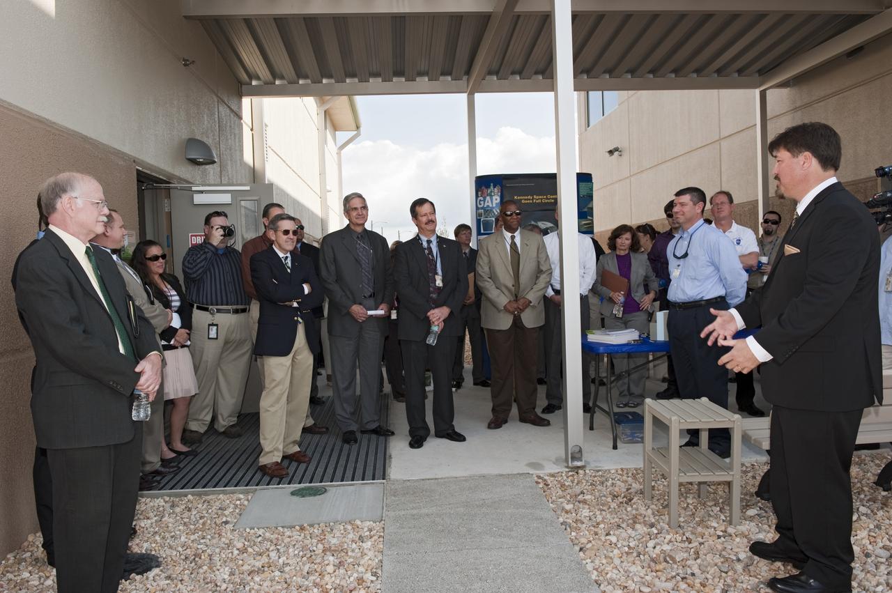 CAPE CANAVERAL, Fla. -- Frank Kline, Construction of Facilities project manager at NASA's Kennedy Space Center in Florida, far right, shows off the environmentally friendly features of the new Propellants North Administration and Maintenance Facility. Propellants North consists of two buildings, one to store cryogenic fuel transfer equipment and one to house personnel who support fueling spacecraft. The recently rebuilt buildings will be NASA's first carbon neutral facility, which means it will produce enough energy on site from renewable sources to offset what it requires to operate. The facility also will reach for the U.S. Green Building Council's Leadership in Environmental and Energy Design (LEED) Platinum status, which is the highest LEED rating. Photo credit: NASA/Kim Shiflett