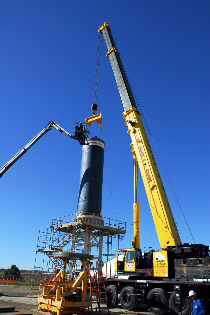 VANDENBERG AIR FORCE BASE, Calif. -- Workers unlatch the crane that lowered Stage 0 of the Orbital Sciences Corp. Taurus XL into launch position on Space Launch Complex 576-E at Vandenberg Air Force Base in California. As part of the four-stage Taurus XL rocket that will carry NASA's Glory spacecraft into low Earth orbit, stages 1, 2 and 3 will join Stage 0 at the launch pad about a week later.      Once Glory reaches orbit, it will collect data on the properties of aerosols and black carbon. It also will help scientists understand how the sun's irradiance affects Earth's climate. Launch is scheduled for 5:09 a.m. EST Feb. 23. For information, visit www.nasa.gov/glory. Photo credit: NASA/Don Kosoksa, VAFB
