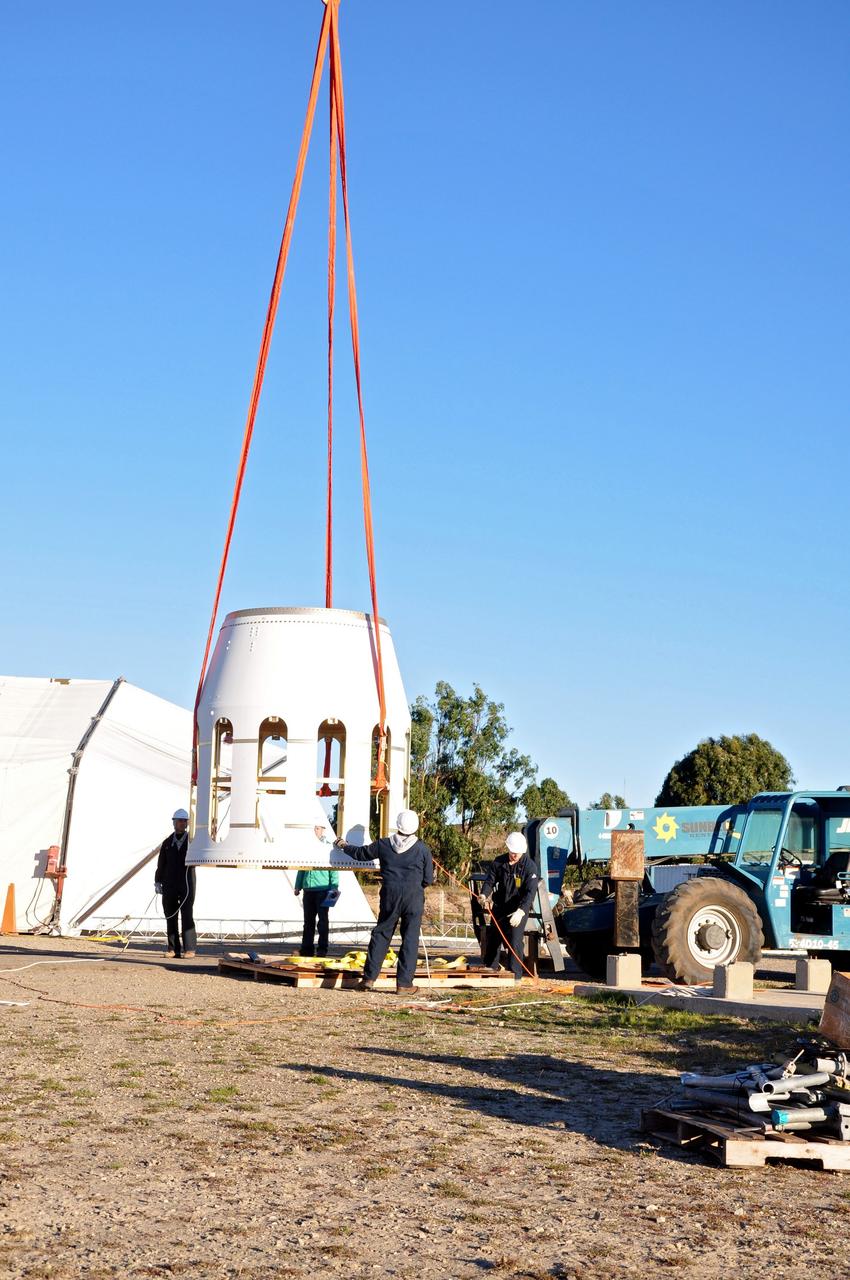 VANDENBERG AIR FORCE BASE, Calif. -- At Vandenberg Air Force Base in California, workers monitor the progress of the Stage 0/1 interstage, part of the four-stage Taurus XL rocket that will carry NASA's Glory spacecraft into low Earth orbit, as a crane hoists it toward the pad at Space Launch Complex 576-E. Once Glory reaches orbit, it will collect data on the properties of aerosols and black carbon. It also will help scientists understand how the sun's irradiance affects Earth's climate. Launch is scheduled for 5:09 a.m. EST Feb. 23. For information, visit www.nasa.gov/glory. Photo credit: NASA/Randy Beaudoin, VAFB