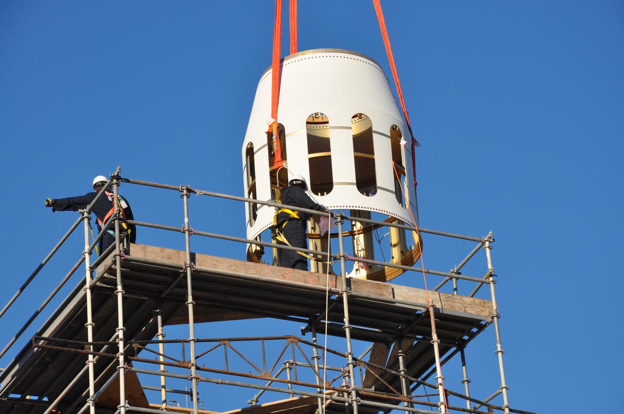 VANDENBERG AIR FORCE BASE, Calif. -- At Vandenberg Air Force Base in California, workers guide the Stage 0/1 interstage, part of the four-stage Taurus XL rocket that will carry NASA's Glory spacecraft into low Earth orbit, as it is lowered by crane into launch position at Space Launch Complex 576-E. Once Glory reaches orbit, it will collect data on the properties of aerosols and black carbon. It also will help scientists understand how the sun's irradiance affects Earth's climate. Launch is scheduled for 5:09 a.m. EST Feb. 23. For information, visit www.nasa.gov/glory. Photo credit: NASA/Randy Beaudoin, VAFB