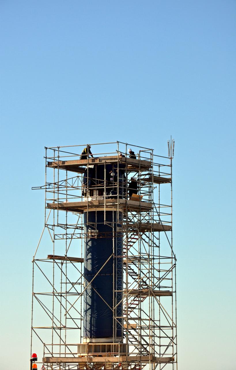 VANDENBERG AIR FORCE BASE, Calif. -- Workers at Space Launch Complex 576-E at Vandenberg Air Force Base in California, wrap the Stage 0/1 interstage in a weather-protective covering after it was secured to Stage 0 of the four-stage Taurus XL rocket that will carry NASA's Glory spacecraft into low Earth orbit. Once Glory reaches orbit, it will collect data on the properties of aerosols and black carbon. It also will help scientists understand how the sun's irradiance affects Earth's climate. Launch is scheduled for 5:09 a.m. EST Feb. 23. For information, visit www.nasa.gov/glory. Photo credit: NASA/Randy Beaudoin, VAFB