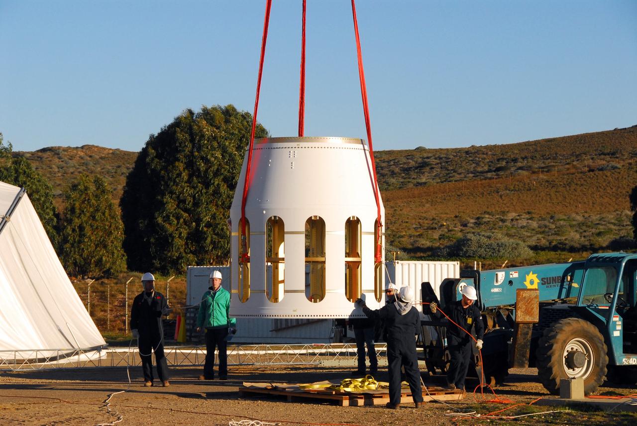 VANDENBERG AIR FORCE BASE, Calif. -- At Vandenberg Air Force Base in California, the Stage 0/1 interstage, part of the four-stage Taurus XL rocket that will carry NASA's Glory spacecraft into low Earth orbit, is lifted by crane toward the pad at Space Launch Complex 576-E.           Once Glory reaches orbit, it will collect data on the properties of aerosols and black carbon. It also will help scientists understand how the sun's irradiance affects Earth's climate. Launch is scheduled for 5:09 a.m. EST Feb. 23. For information, visit www.nasa.gov/glory. Photo credit: NASA/Roy Allison, VAFB