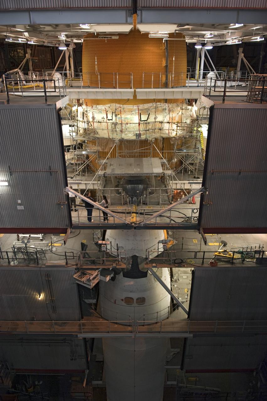 CAPE CANAVERAL, Fla. -- Repair work to space shuttle Discovery's external fuel tank begins to wrap up in the Vehicle Assembly Building at NASA's Kennedy Space Center in Florida. Technicians modified 94 support beams, called stringers, on the tank's intertank region by fitting pieces of metal, called radius blocks, over the stringers' edges. They also were re-applying foam to the modified areas of the tank. Attached to its fuel tank and two solid rocket boosters, Discovery is scheduled to roll out to Launch Pad 39A atop a giant crawler-transporter on Jan. 31.              Discovery's next launch opportunity to the International Space Station on the STS-133 mission is targeted for Feb. 24. For more information on STS-133, visit www.nasa.gov/mission_pages/shuttle/shuttlemissions/sts133/. Photo credit: NASA/Kim Shiflett
