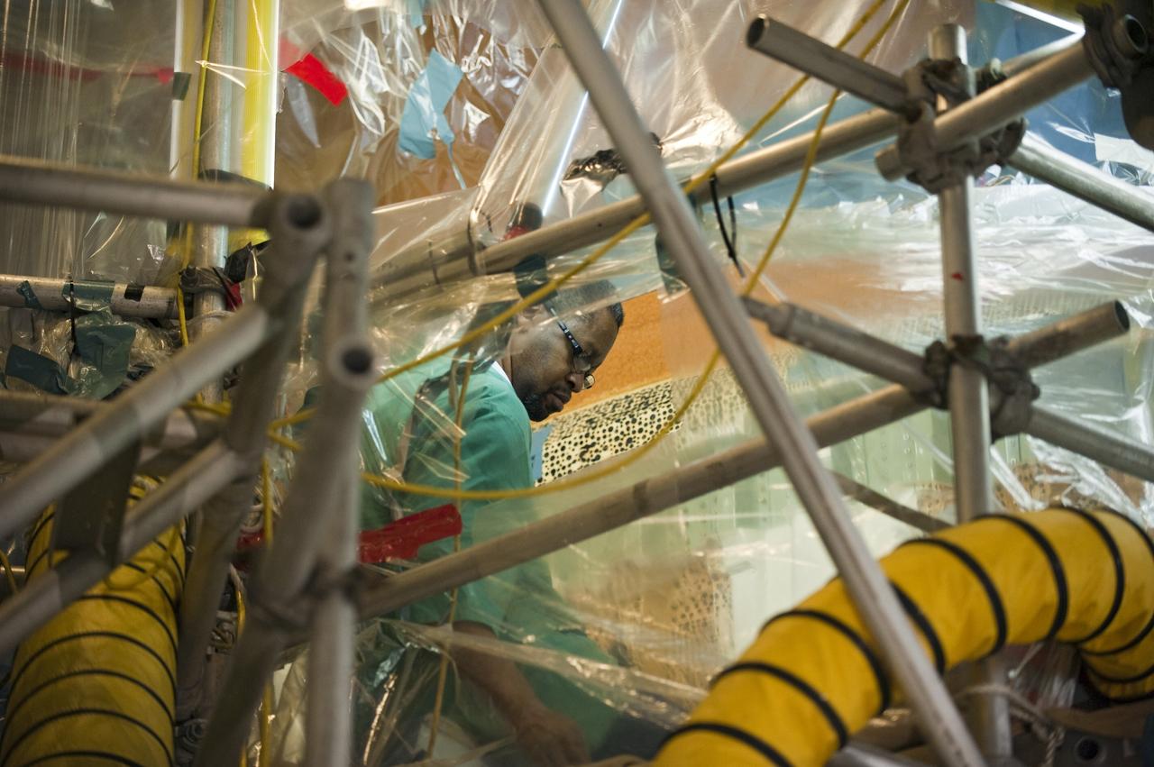 CAPE CANAVERAL, Fla. -- Repair work to space shuttle Discovery's external fuel tank begins to wrap up in the Vehicle Assembly Building at NASA's Kennedy Space Center in Florida. Technicians modified 94 support beams, called stringers, on the tank's intertank region by fitting pieces of metal, called radius blocks, over the stringers' edges. They also were re-applying foam to the modified areas of the tank. Attached to its fuel tank and two solid rocket boosters, Discovery is scheduled to roll out to Launch Pad 39A atop a giant crawler-transporter on Jan. 31.              Discovery's next launch opportunity to the International Space Station on the STS-133 mission is targeted for Feb. 24. For more information on STS-133, visit www.nasa.gov/mission_pages/shuttle/shuttlemissions/sts133/. Photo credit: NASA/Kim Shiflett