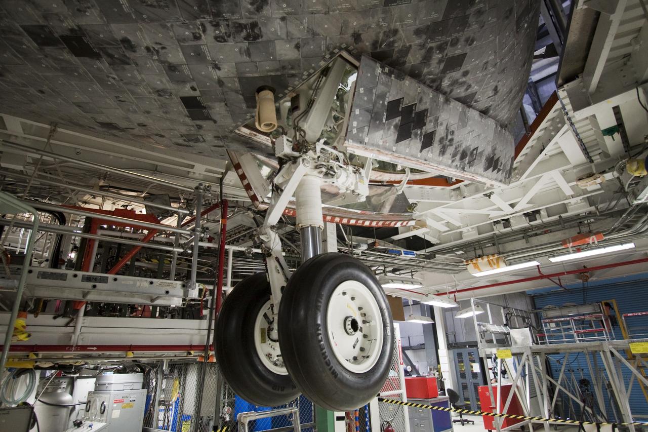 CAPE CANAVERAL, Fla. -- Space shuttle Atlantis  goes through a routine landing gear test in Orbiter Processing Facility-1 at NASA's Kennedy Space Center in Florida. Technicians are checking to make sure the shuttle's wheels, brakes, elevons and body flap function properly. Seen here, the nose landing gear is deployed. During a shuttle landing, the nose gear comes down after the main gear and helps the shuttle coast to a stop.            Atlantis is being prepared for the STS-135 mission, which will deliver the Raffaello multi-purpose logistics module packed with supplies, logistics and spare parts to the International Space Station. STS-135 is targeted to launch June 28, and will be the last spaceflight for the Space Shuttle Program. Photo credit: NASA/Jack Pfaller