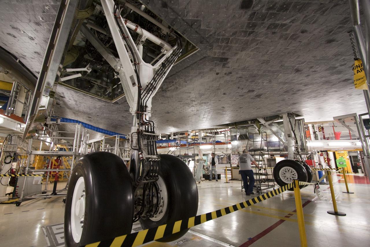 CAPE CANAVERAL, Fla. -- Space shuttle Atlantis  goes through a routine landing gear test in Orbiter Processing Facility-1 at NASA's Kennedy Space Center in Florida. Technicians are checking to make sure the shuttle's wheels, brakes, elevons and body flap function properly. Seen here, the nose landing gear is deployed. During a shuttle landing, the nose gear comes down after the main gear and helps the shuttle coast to a stop.            Atlantis is being prepared for the STS-135 mission, which will deliver the Raffaello multi-purpose logistics module packed with supplies, logistics and spare parts to the International Space Station. STS-135 is targeted to launch June 28, and will be the last spaceflight for the Space Shuttle Program. Photo credit: NASA/Jack Pfaller