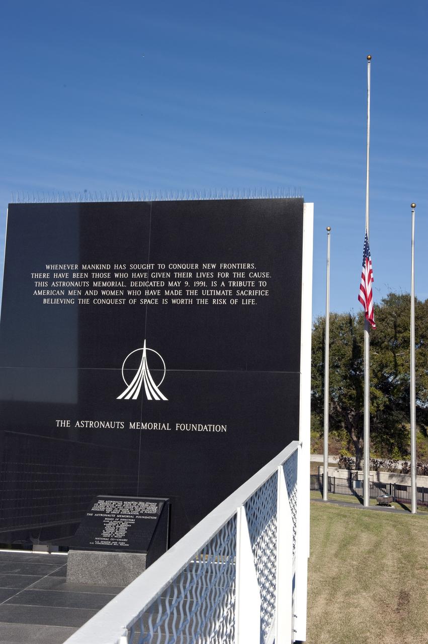 CAPE CANAVERAL, Fla. -- A flag flies at half-staff near the Space Mirror Memorial at the Kennedy Space Center Visitor Complex in Florida during a Day of Remembrance wreath laying ceremony to honor members of the NASA family who lost their lives while furthering the cause of exploration and discovery. The large mirror made of black granite was designated as a national memorial by Congress and President George Bush in 1991. It honors 24 United States astronauts, including the crew members of space shuttles Columbia and Challenger, Apollo 1, and those who died in training and commercial airplane accidents.             The memorial is a project of the Astronauts Memorial Foundation and was paid for by Florida residents who purchased special Challenger mission automobile license plates. 2011 marks the 25th anniversary of the loss of Challenger, which broke apart over the Atlantic Ocean 73 seconds into flight on Jan. 28, 1986. Photo credit: NASA/Kim Shiflett