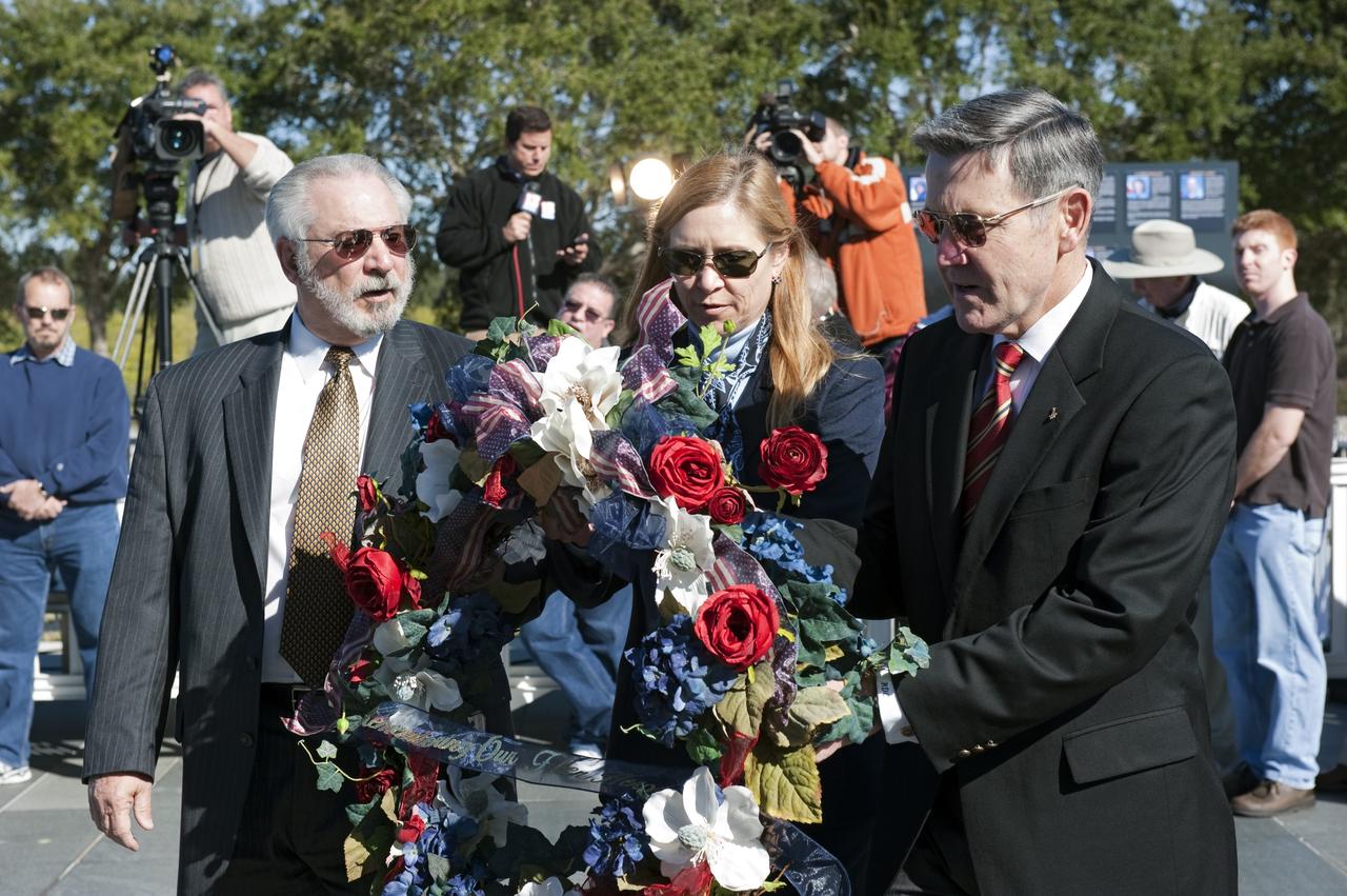 CAPE CANAVERAL, Fla. -- United Space Alliance's Associate Program Manager for Solid Rocket Boosters Roger Elliott, left, Kennedy Space Center Deputy Director Janet Petro, and Center Director and former astronaut Bob Cabana, participate in a Day of Remembrance wreath laying ceremony at the Space Mirror Memorial at the Kennedy Space Center Visitor Complex in Florida. The ceremony honors members of the NASA family who lost their lives while furthering the cause of exploration and discovery. The memorial displays the names of 24 United States astronauts, including the crew members of space shuttles Columbia and Challenger, Apollo 1, and those who died in training and commercial airplane accidents.                 The memorial is a project of the Astronauts Memorial Foundation and was paid for by Florida residents who purchased special Challenger mission automobile license plates. 2011 marks the 25th anniversary of the loss of Challenger, which broke apart over the Atlantic Ocean 73 seconds into flight on Jan. 28, 1986. Photo credit: NASA/Kim Shiflett