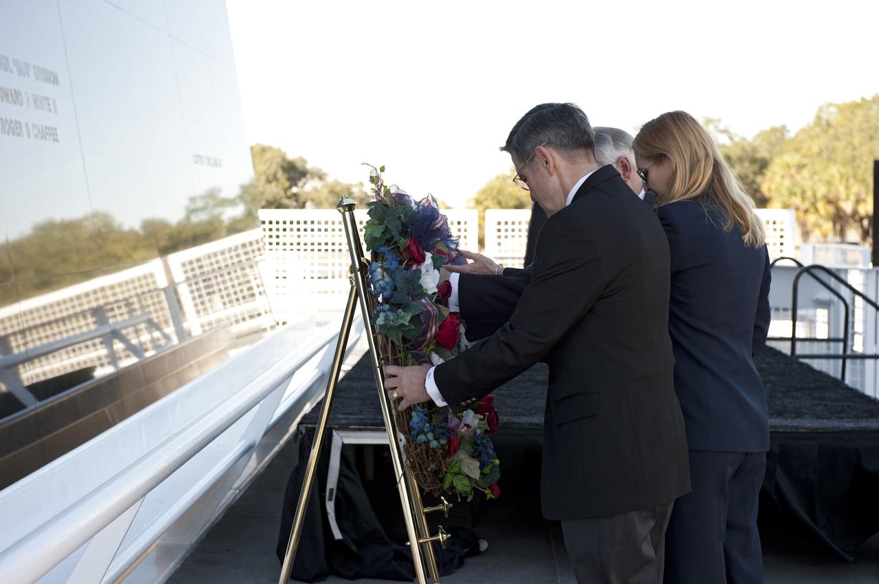 CAPE CANAVERAL, Fla. -- United Space Alliance's Associate Program Manager for Solid Rocket Boosters Roger Elliott, back, Kennedy Space Center Deputy Director Janet Petro, and Center Director and former astronaut Bob Cabana, participate in a Day of Remembrance wreath laying ceremony at the Space Mirror Memorial at the Kennedy Space Center Visitor Complex in Florida. The ceremony honors members of the NASA family who lost their lives while furthering the cause of exploration and discovery. The memorial displays the names of 24 United States astronauts, including the crew members of space shuttles Columbia and Challenger, Apollo 1, and those who died in training and commercial airplane accidents.                  The memorial is a project of the Astronauts Memorial Foundation and was paid for by Florida residents who purchased special Challenger mission automobile license plates. 2011 marks the 25th anniversary of the loss of Challenger, which broke apart over the Atlantic Ocean 73 seconds into flight on Jan. 28, 1986. Photo credit: NASA/Kim Shiflett