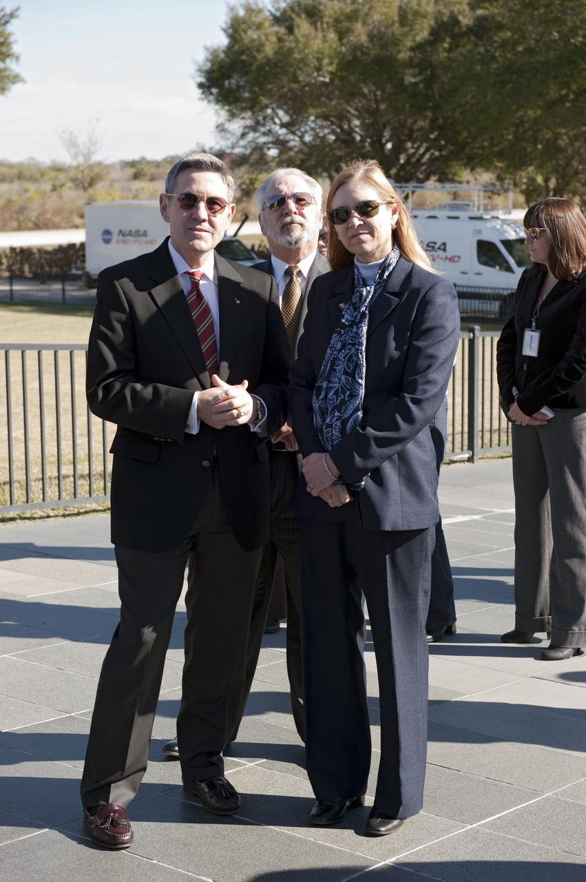 CAPE CANAVERAL, Fla. -- Kennedy Space Center Director and former astronaut Bob Cabana, left, United Space Alliance's Associate Program Manager for Solid Rocket Boosters Roger Elliott and Center Deputy Director Janet Petro participate in a Day of Remembrance wreath laying ceremony at the Space Mirror Memorial at the Kennedy Space Center Visitor Complex in Florida. The ceremony honors members of the NASA family who lost their lives while furthering the cause of exploration and discovery. The memorial displays the names of 24 United States astronauts, including the crew members of space shuttles Columbia and Challenger, Apollo 1, and those who died in training and commercial airplane accidents.                   The memorial is a project of the Astronauts Memorial Foundation and was paid for by Florida residents who purchased special Challenger mission automobile license plates. 2011 marks the 25th anniversary of the loss of Challenger, which broke apart over the Atlantic Ocean 73 seconds into flight on Jan. 28, 1986. Photo credit: NASA/Kim Shiflett
