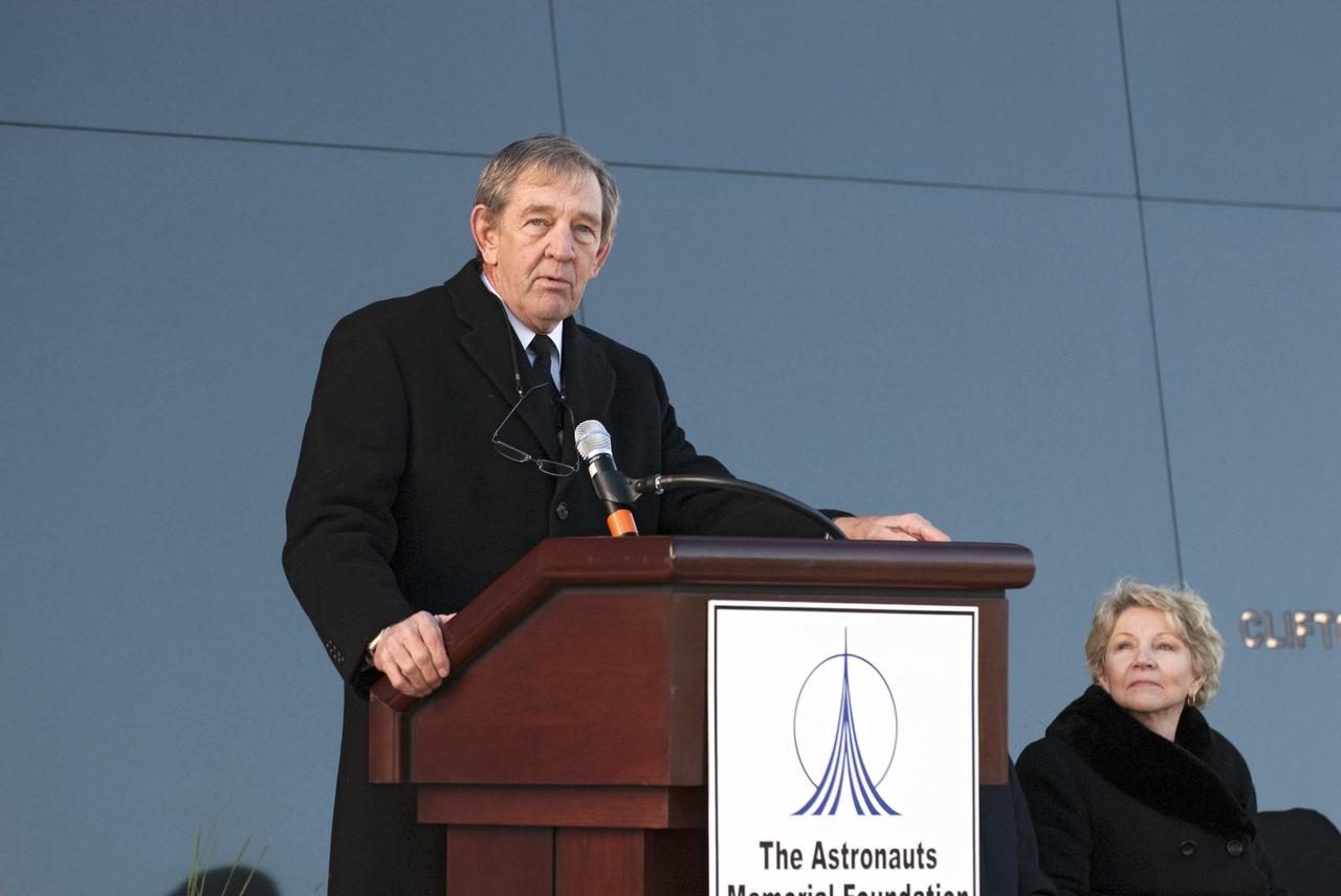 CAPE CANAVERAL, Fla. -- Former astronaut and Chairman of The Astronauts Memorial Foundation Michael McCulley speaks to a crowd gathered in front of the Space Mirror Memorial at the Kennedy Space Center Visitor Complex in Florida to honor space shuttle Challenger's STS-51L crew members who gave their lives for while furthering the cause of exploration and discovery. 2011 marks the 25th anniversary of the loss of Challenger, which broke apart over the Atlantic Ocean 73 seconds into flight on Jan. 28, 1986.           Photo credit: NASA/Kim Shiflett