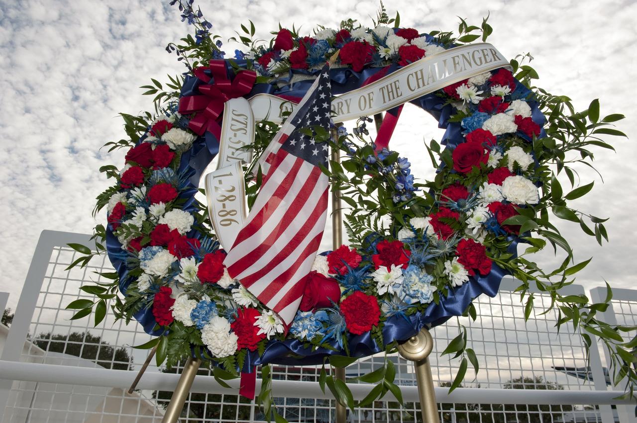 CAPE CANAVERAL, Fla. -- A wreath is displayed at the foot of the Space Mirror Memorial at the Kennedy Space Center Visitor Complex in Florida during a ceremony to honor space shuttle Challenger's STS-51L crew members who gave their lives for while furthering the cause of exploration and discovery. 2011 marks the 25th anniversary of the loss of Challenger, which broke apart over the Atlantic Ocean 73 seconds into flight on Jan. 28, 1986.  Photo credit: NASA/Kim Shiflett